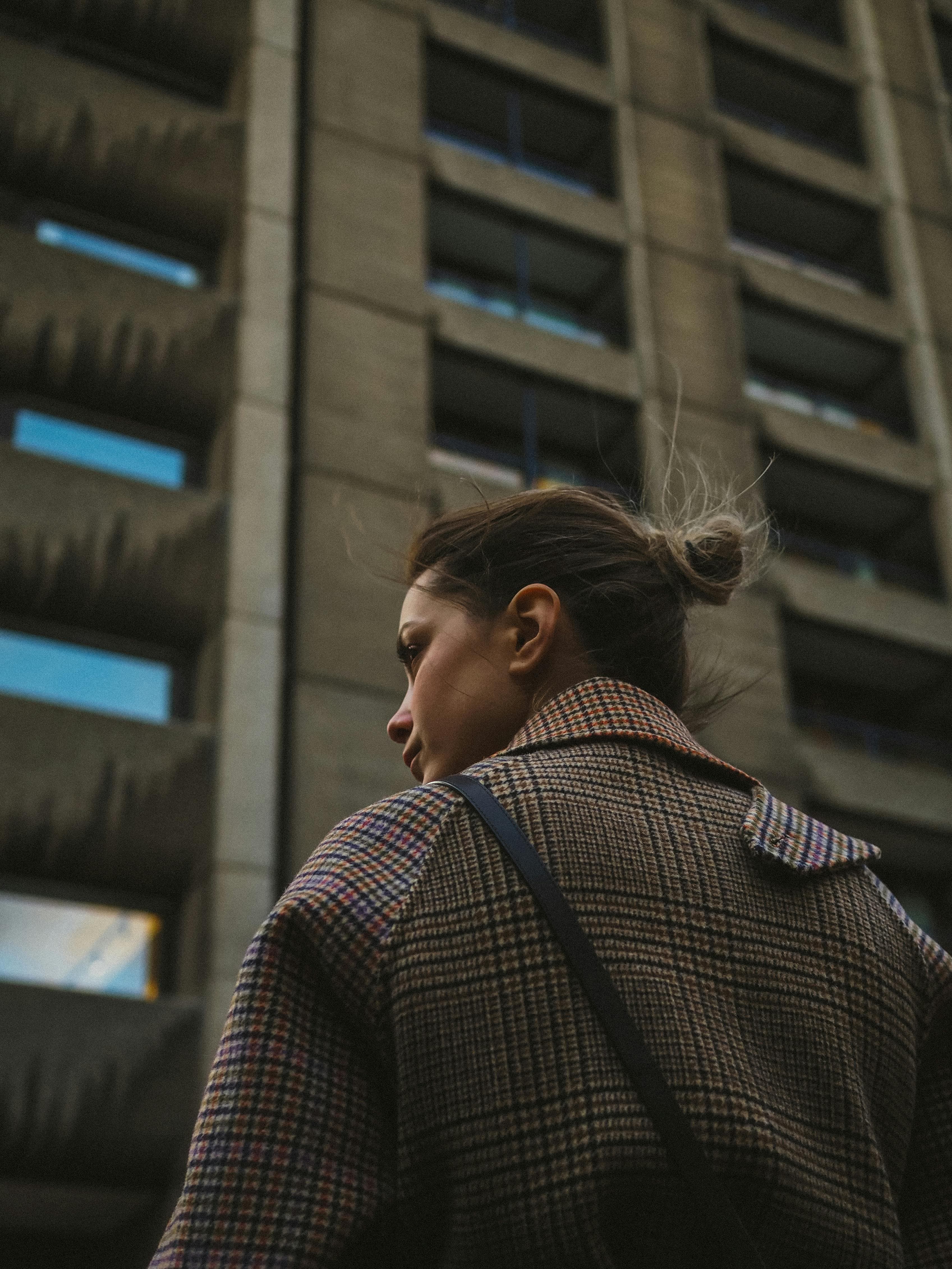 A person experiencing dizziness while looking down from a tall building or cliff
