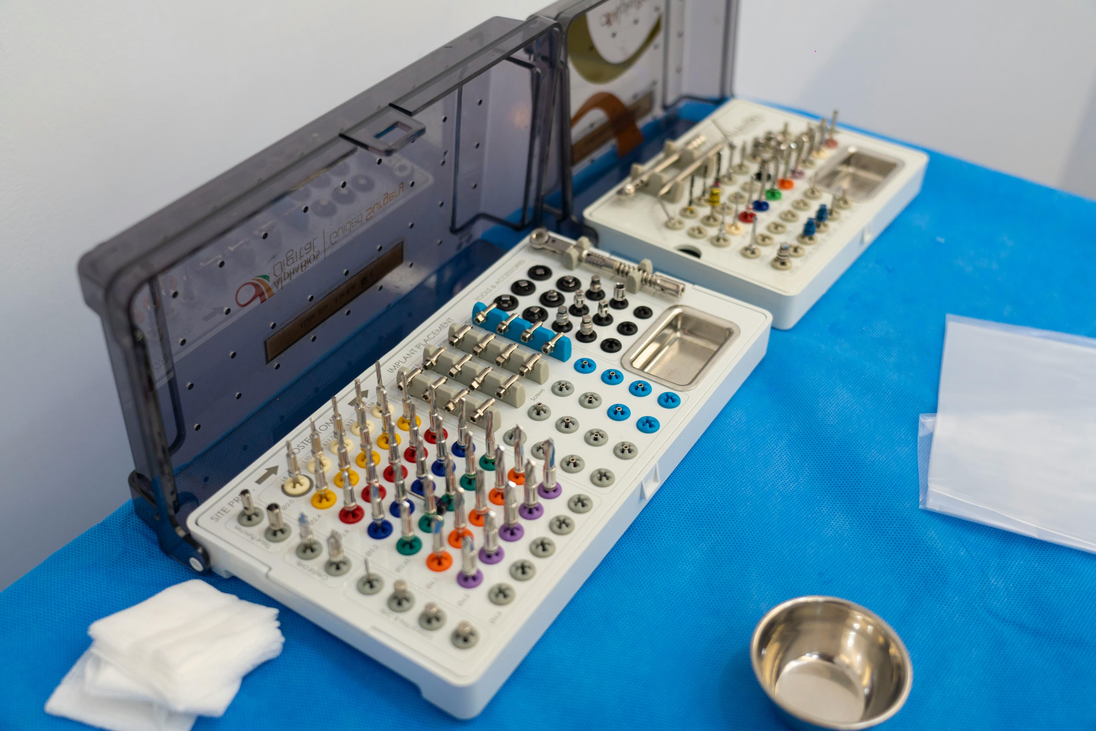 A dentist carefully placing a ceramic implant during a surgical procedure