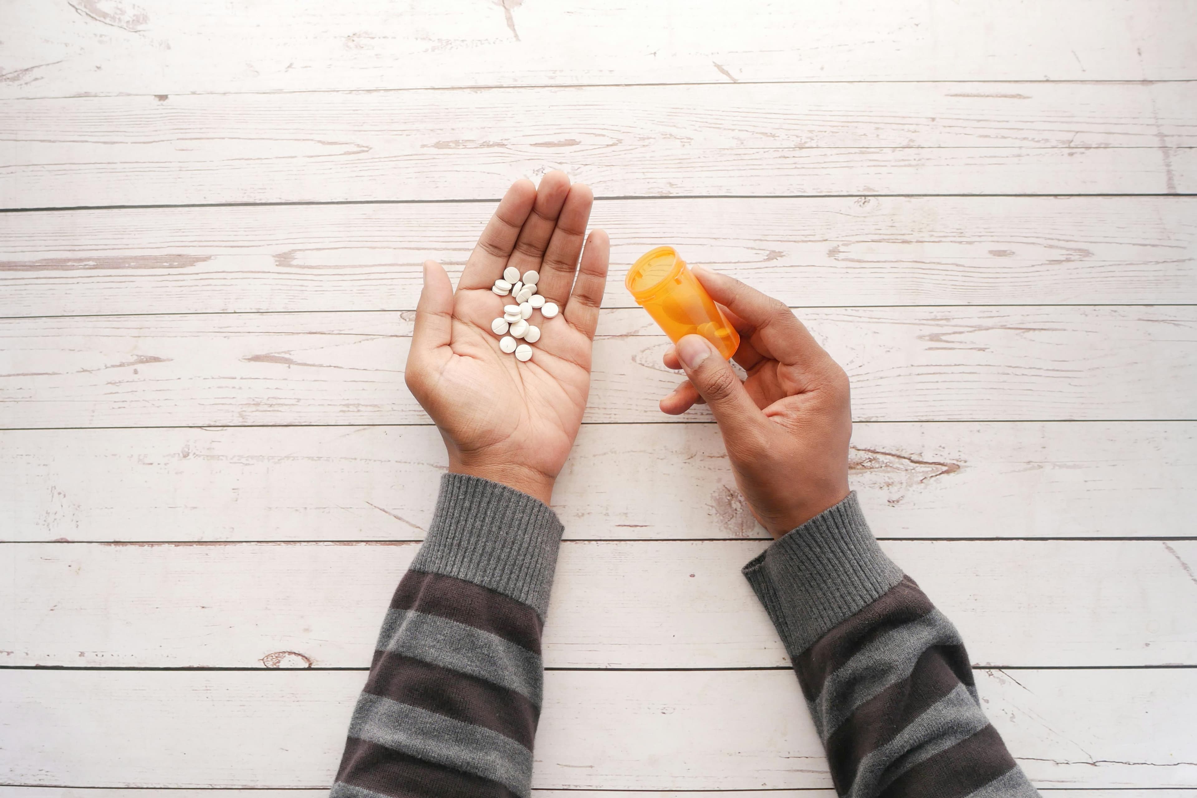 A prescription bottle next to an eye chart, symbolizing optometric prescribing powers