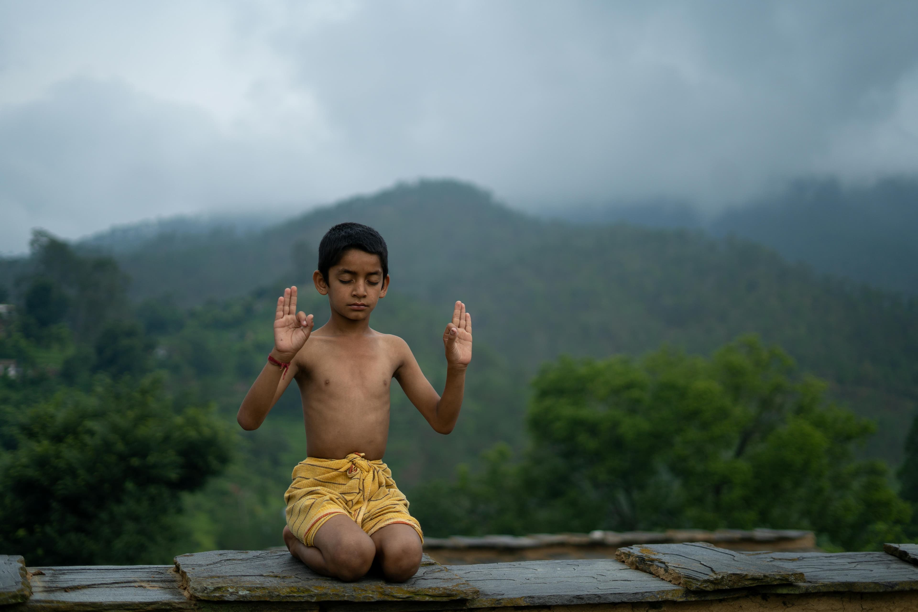 A person practicing yoga outdoors, surrounded by nature, representing a healthy lifestyle