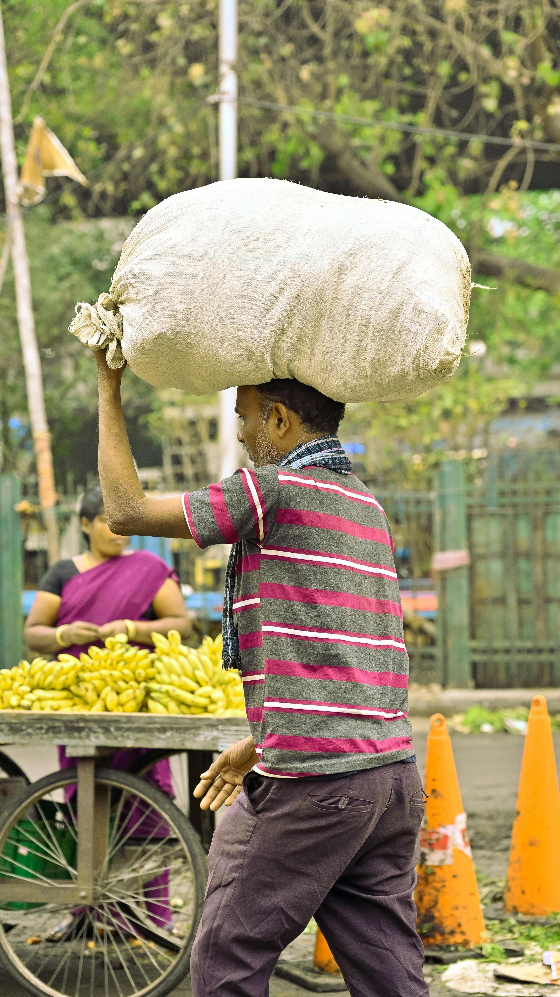 Person carrying a heavy bag with visible strain on their posture