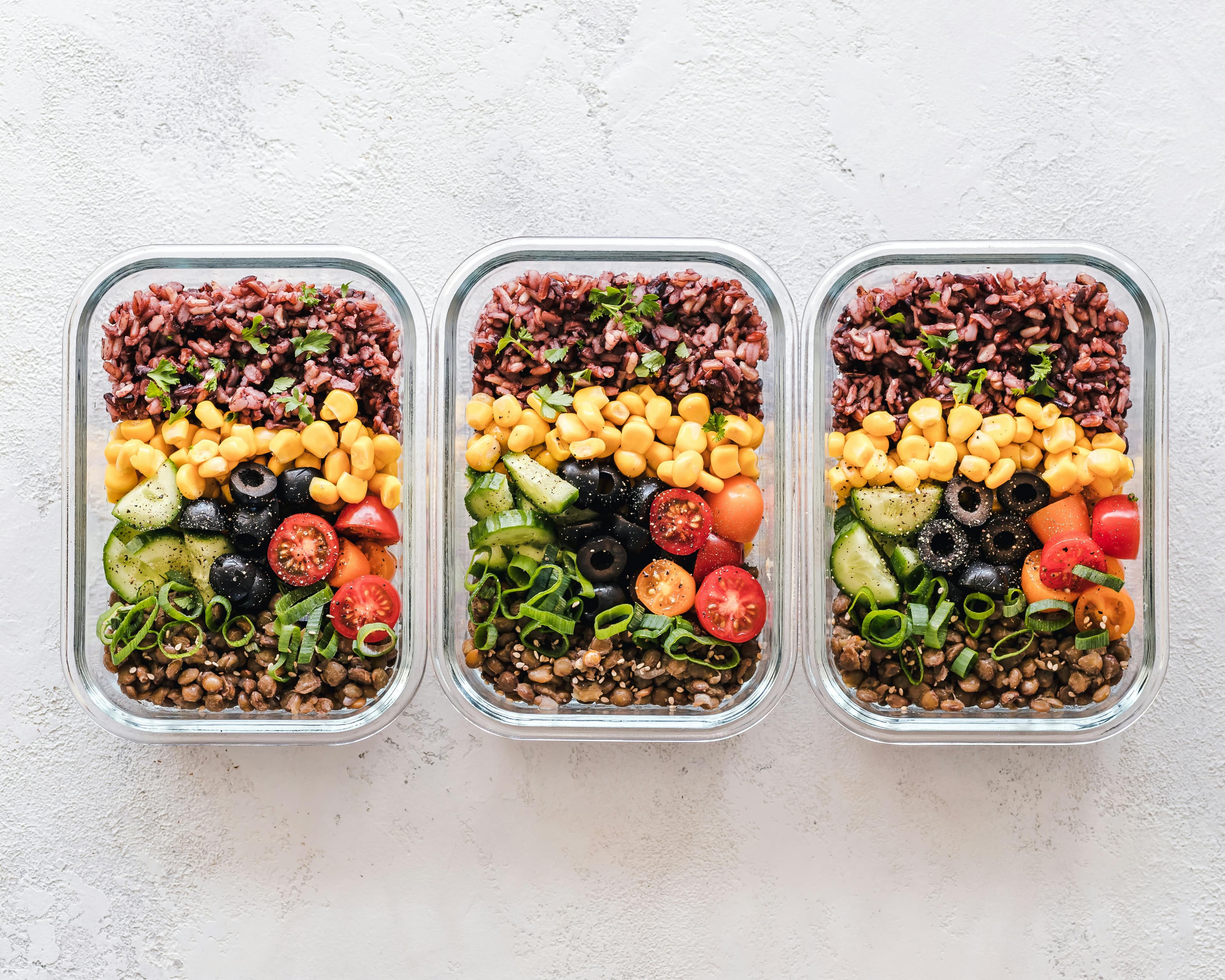 Various containers filled with healthy meal prep options