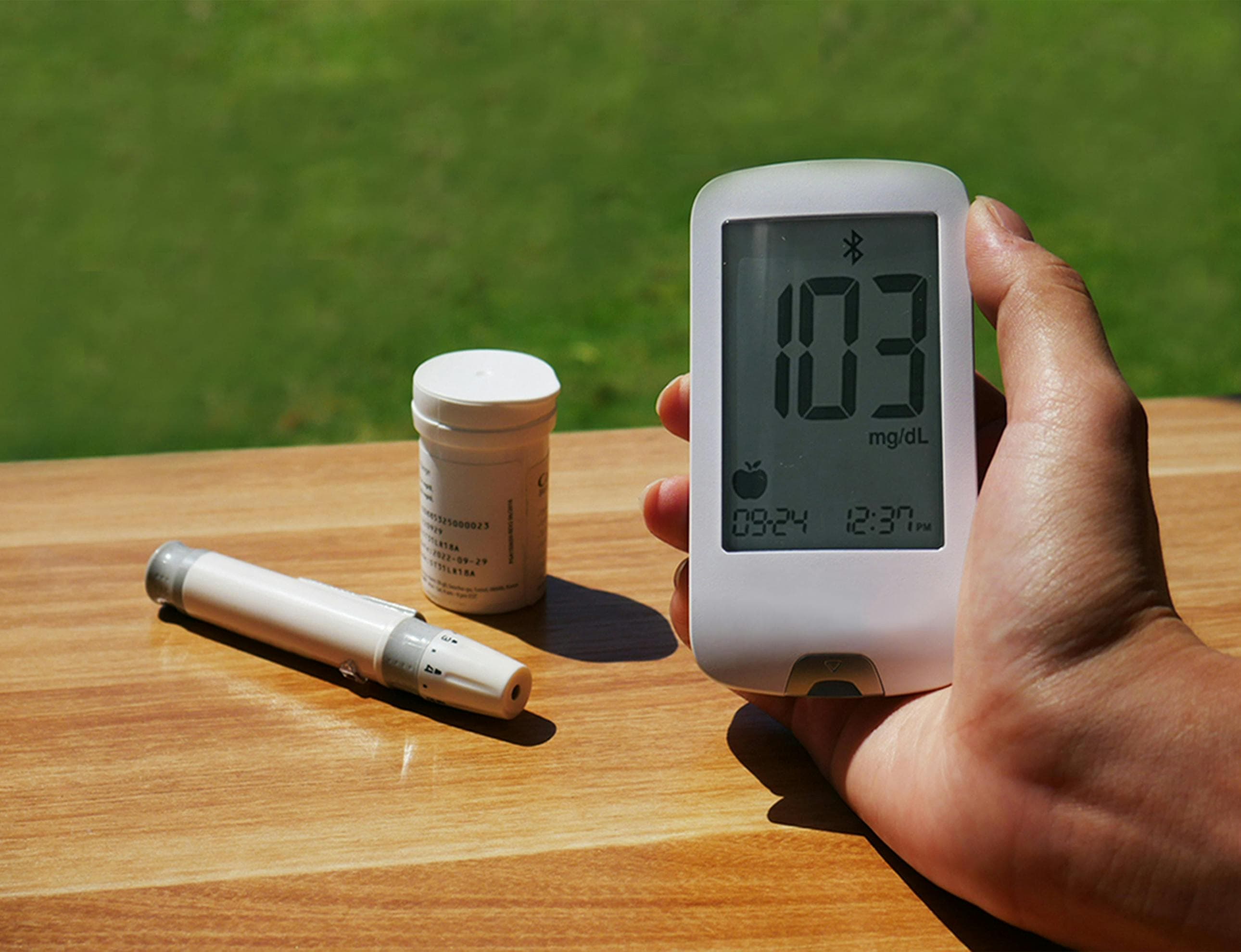 A digital blood pressure monitor displaying elevated readings
