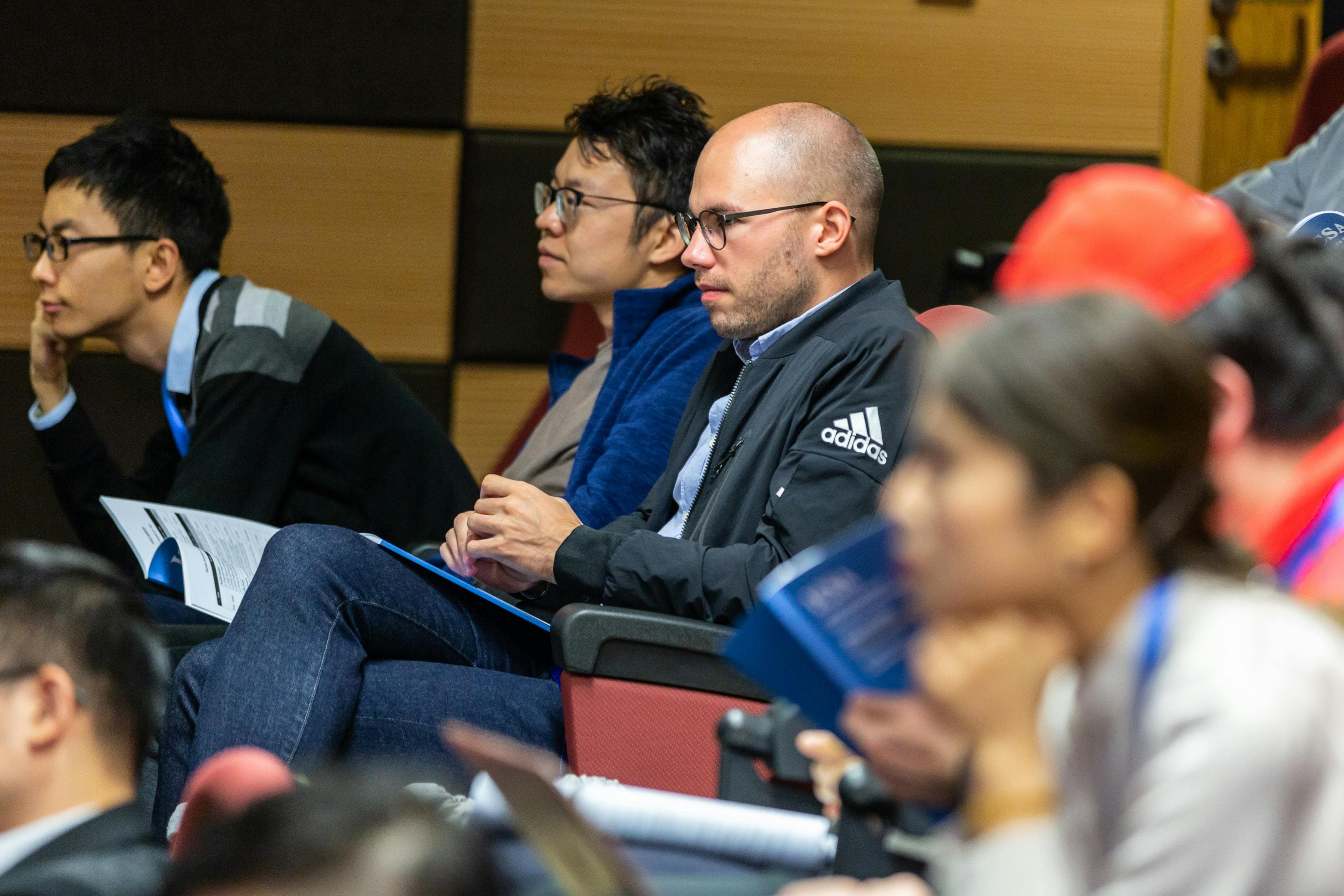 A large auditorium filled with medical professionals attending a dermatology conference