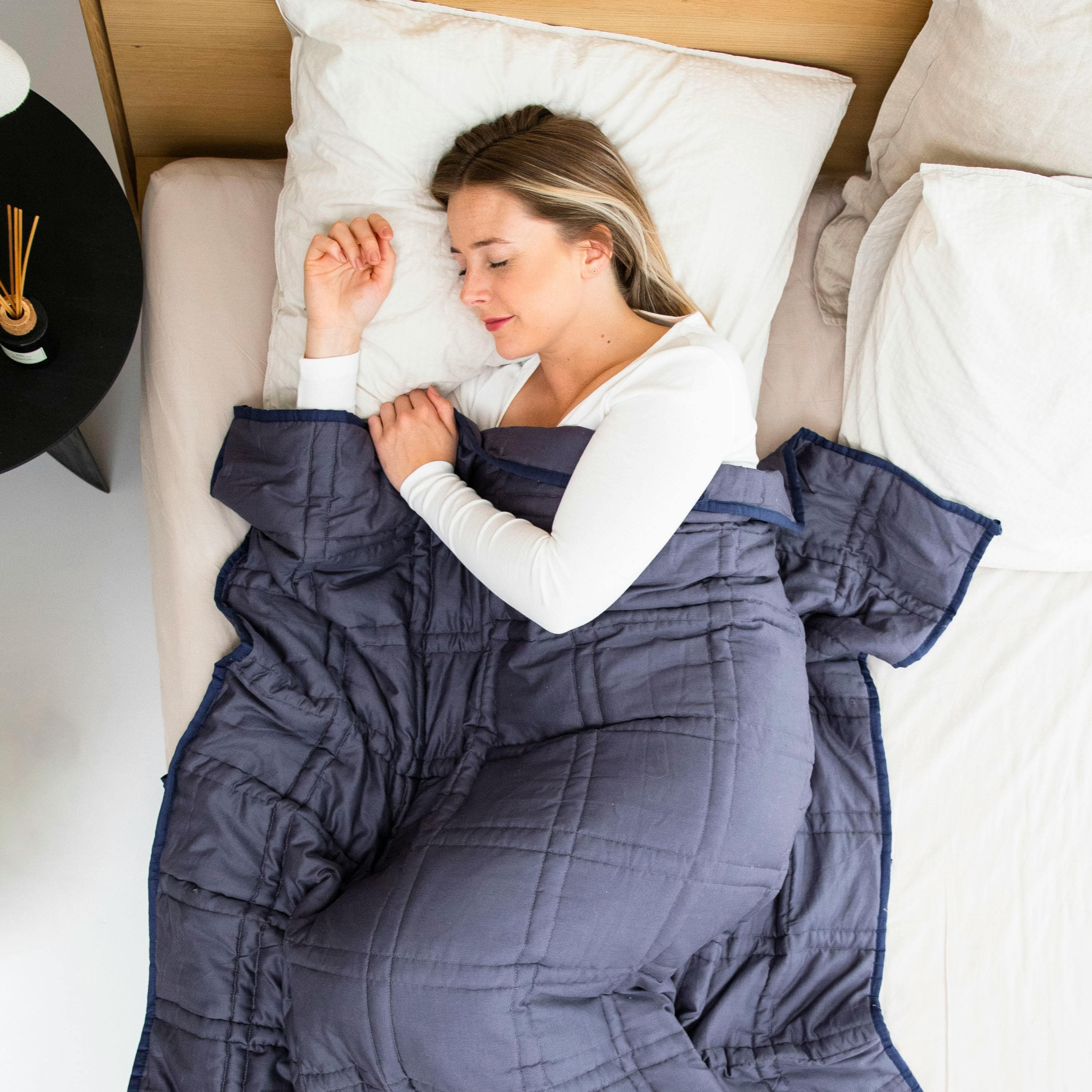 Person sleeping with head elevated on multiple pillows