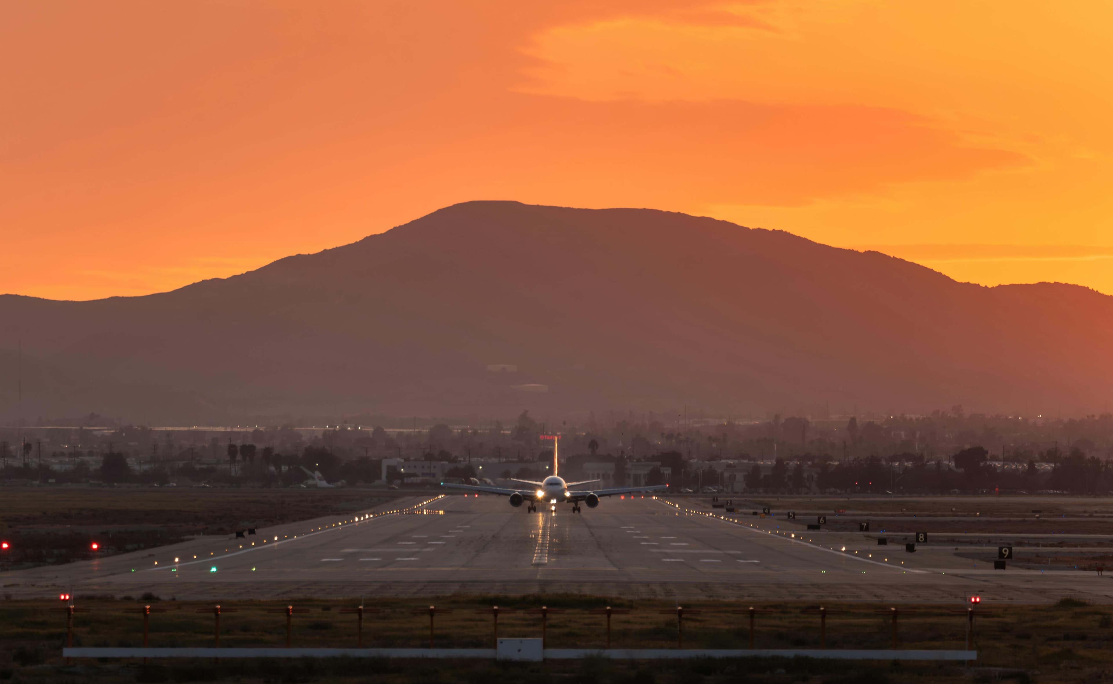 An airplane landing on a runway, symbolizing the end of a flight journey