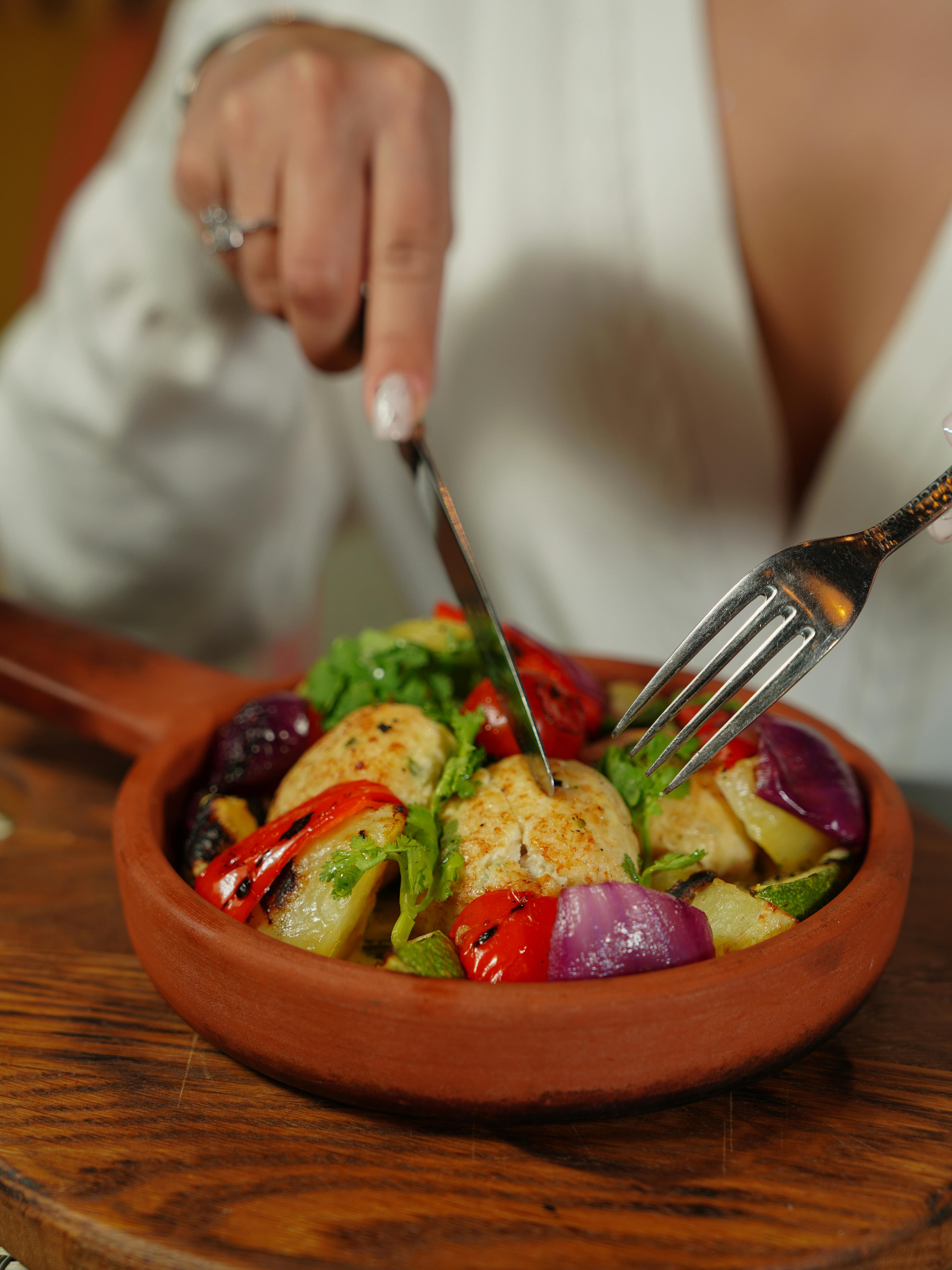 A pregnant woman eating a healthy meal with fruits and vegetables