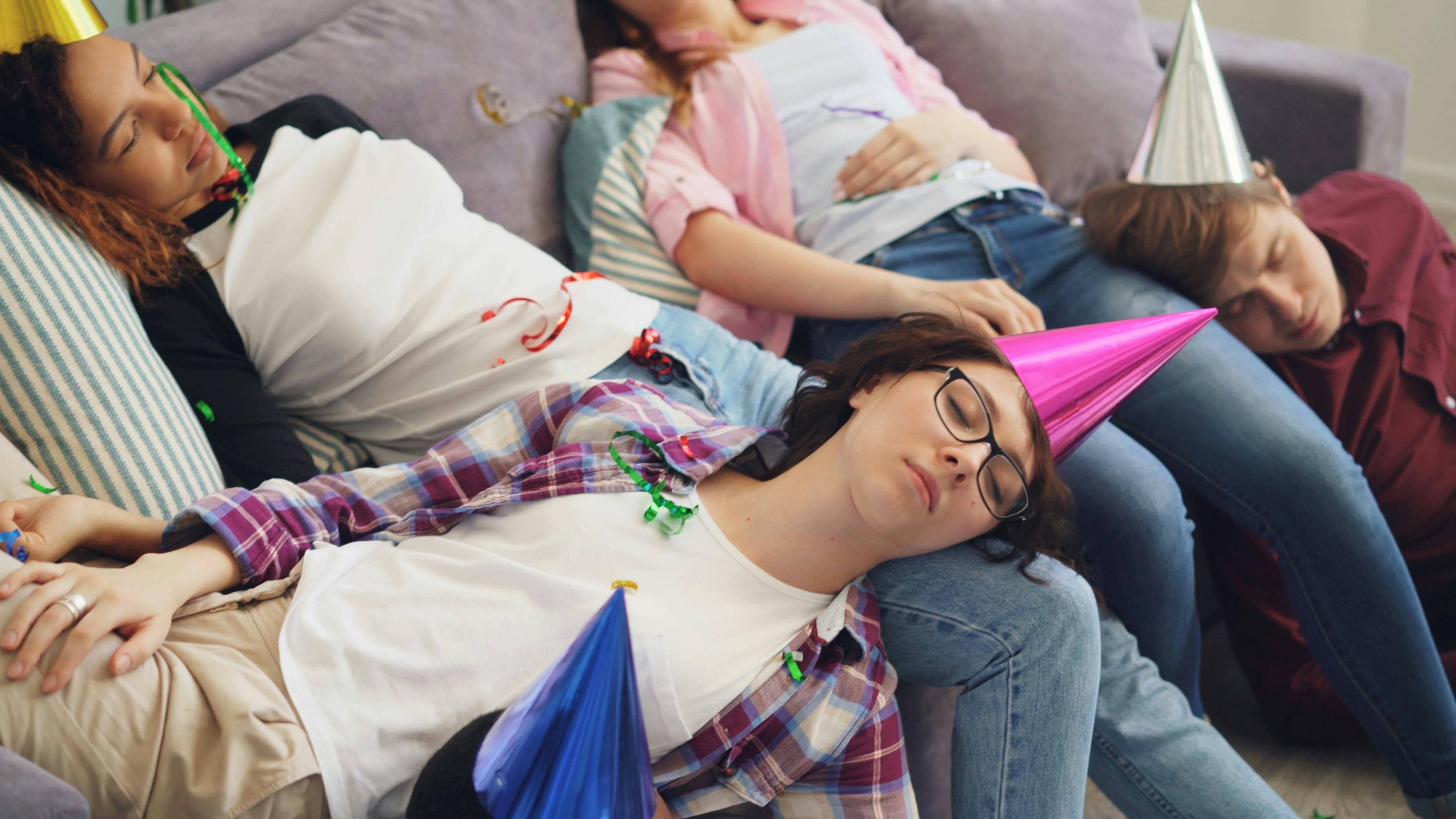 A person looking tired and resting on a couch after a dental procedure