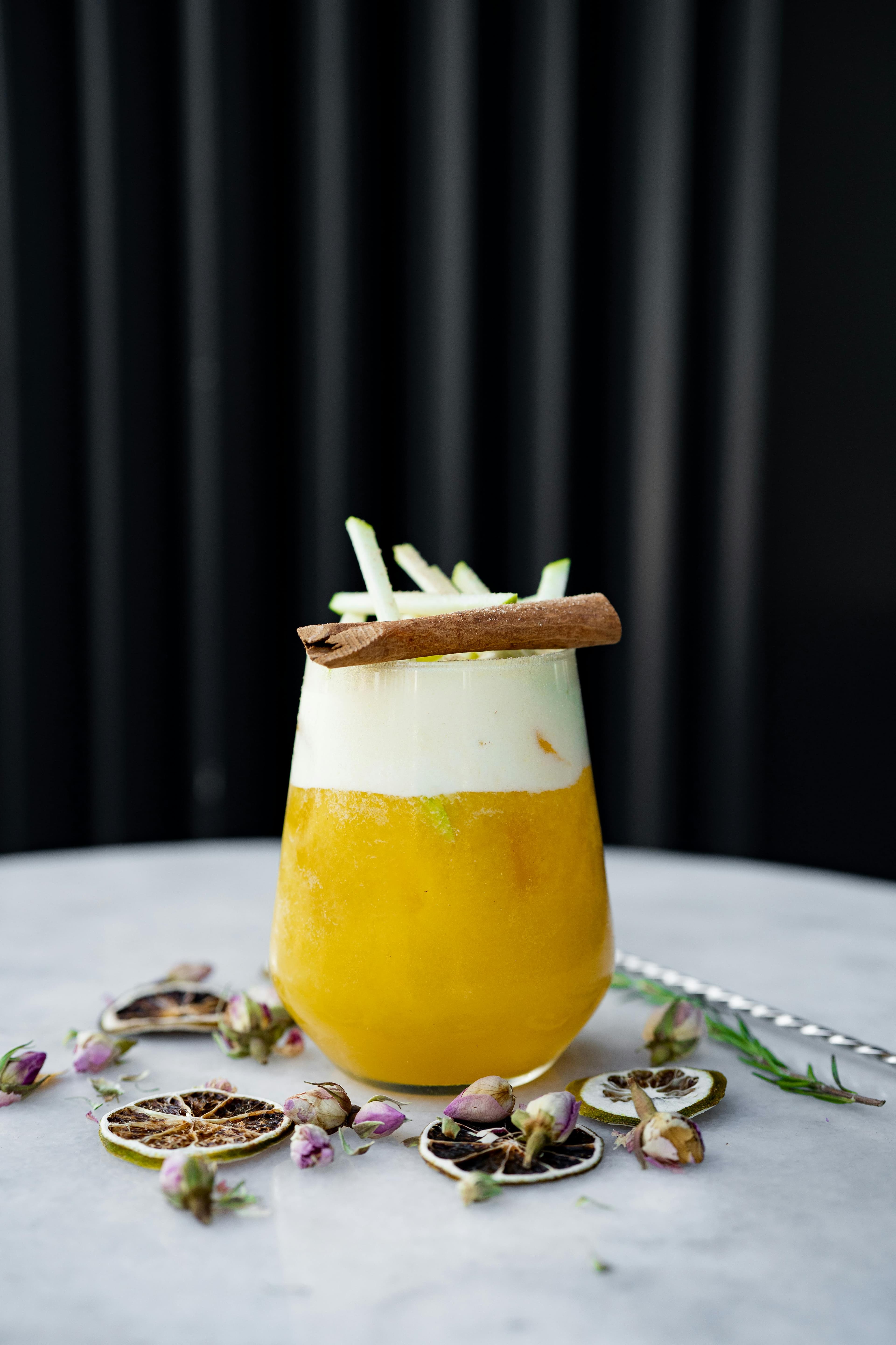A glass of diluted apple cider vinegar drink on a bedside table