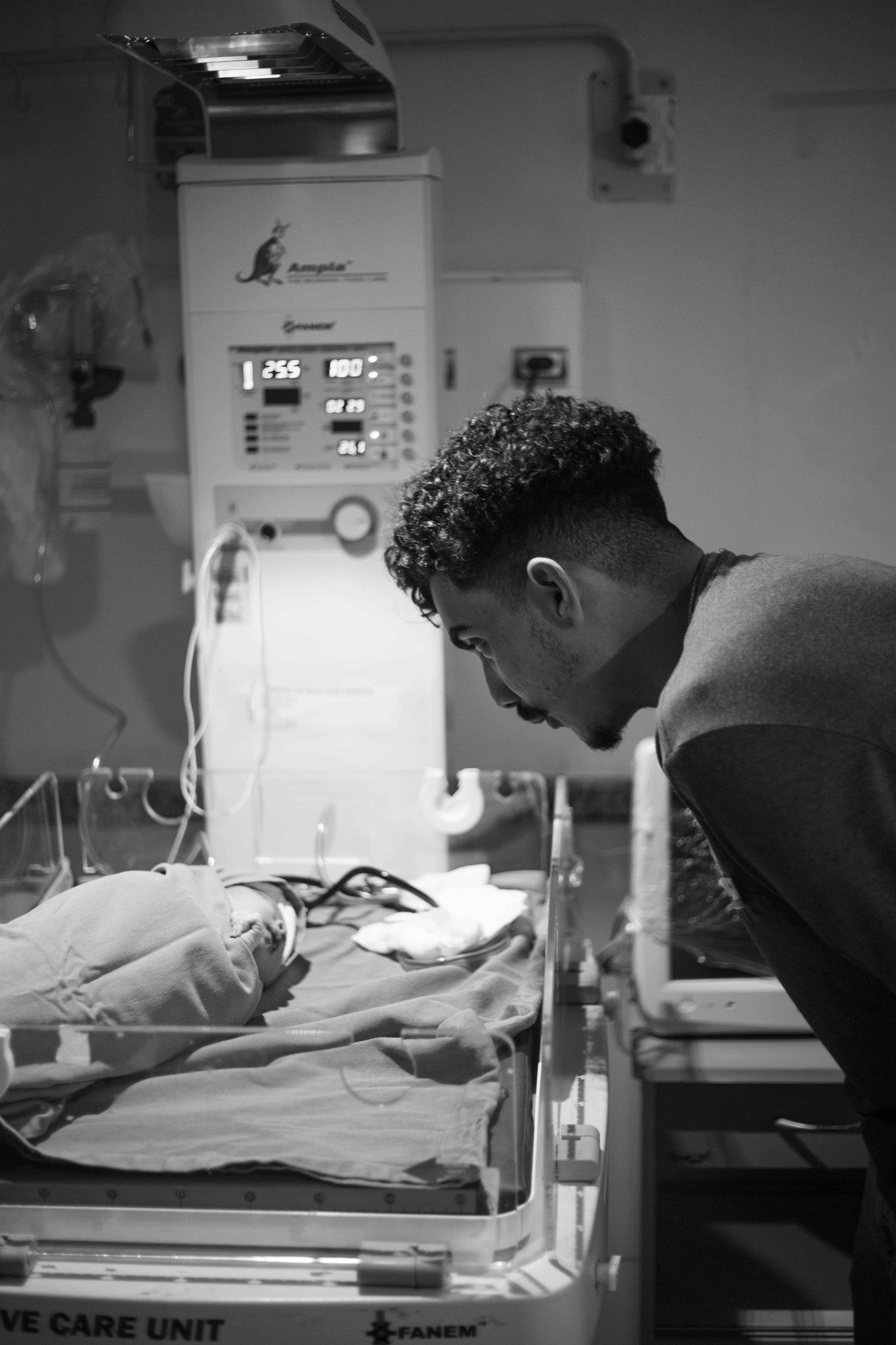 A quiet, dimly lit neonatal intensive care unit (NICU) with incubators