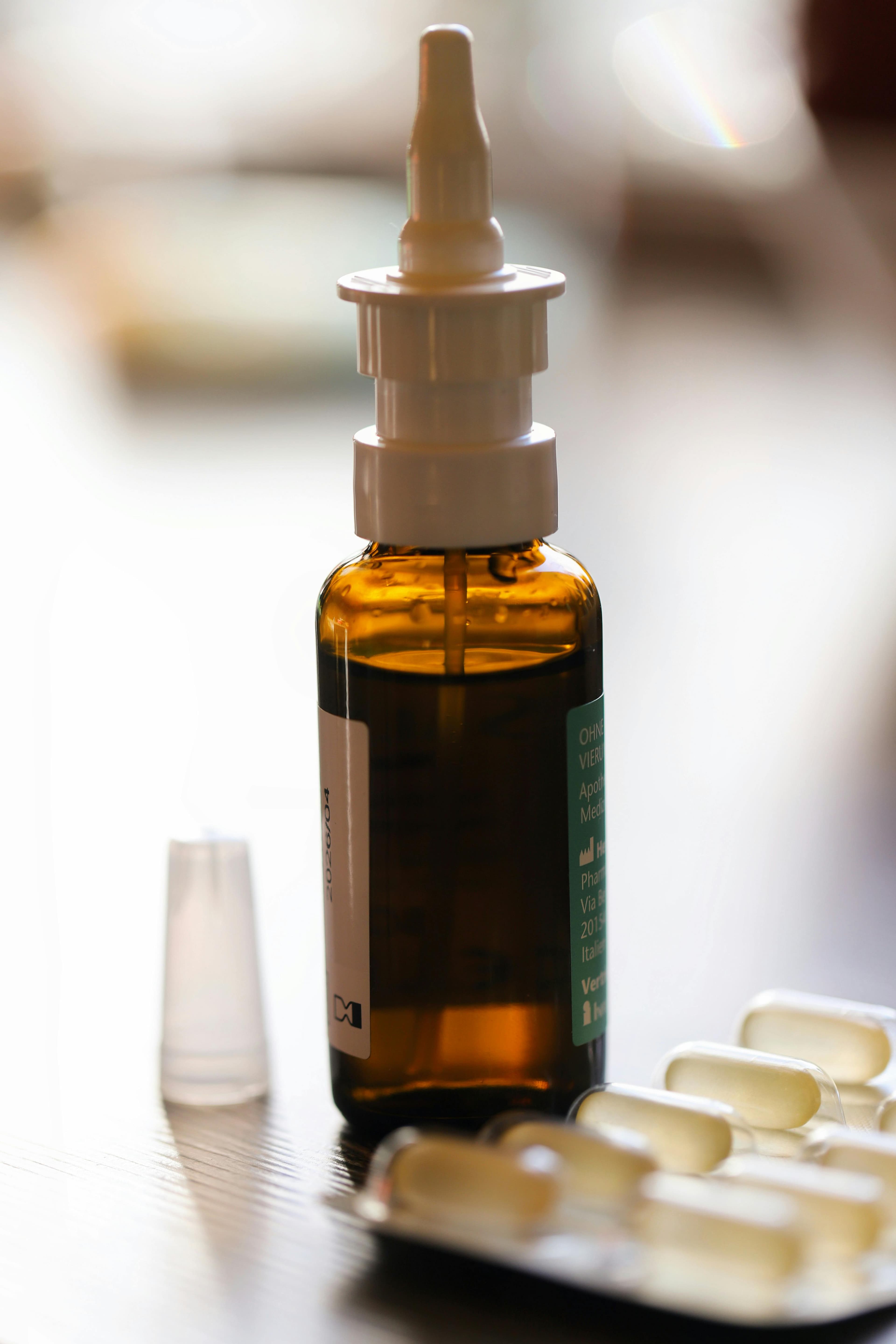 Various over-the-counter allergy nasal sprays displayed on a pharmacy shelf