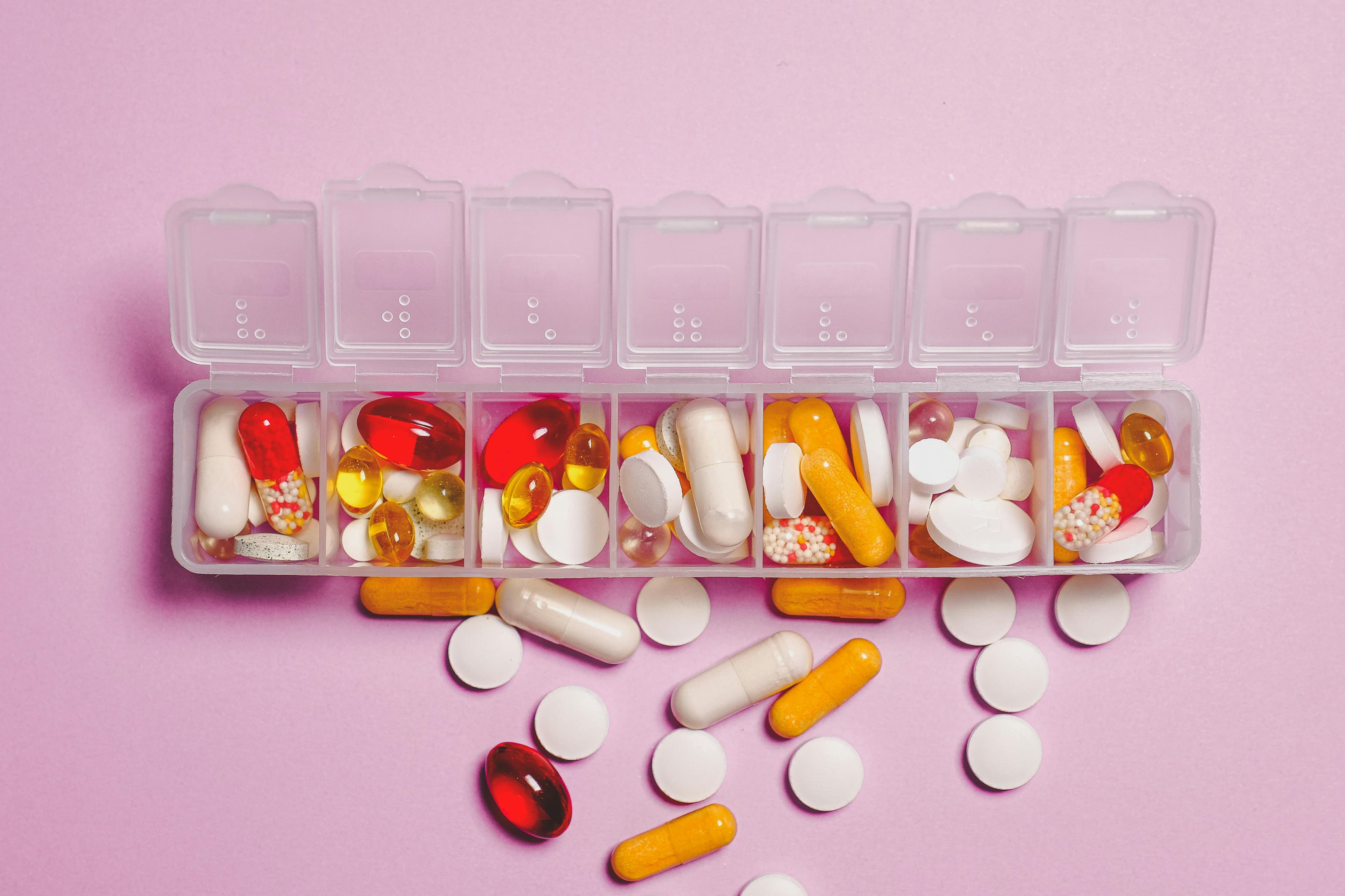 Various prednisone tablets and a pill organizer for managing gout treatment