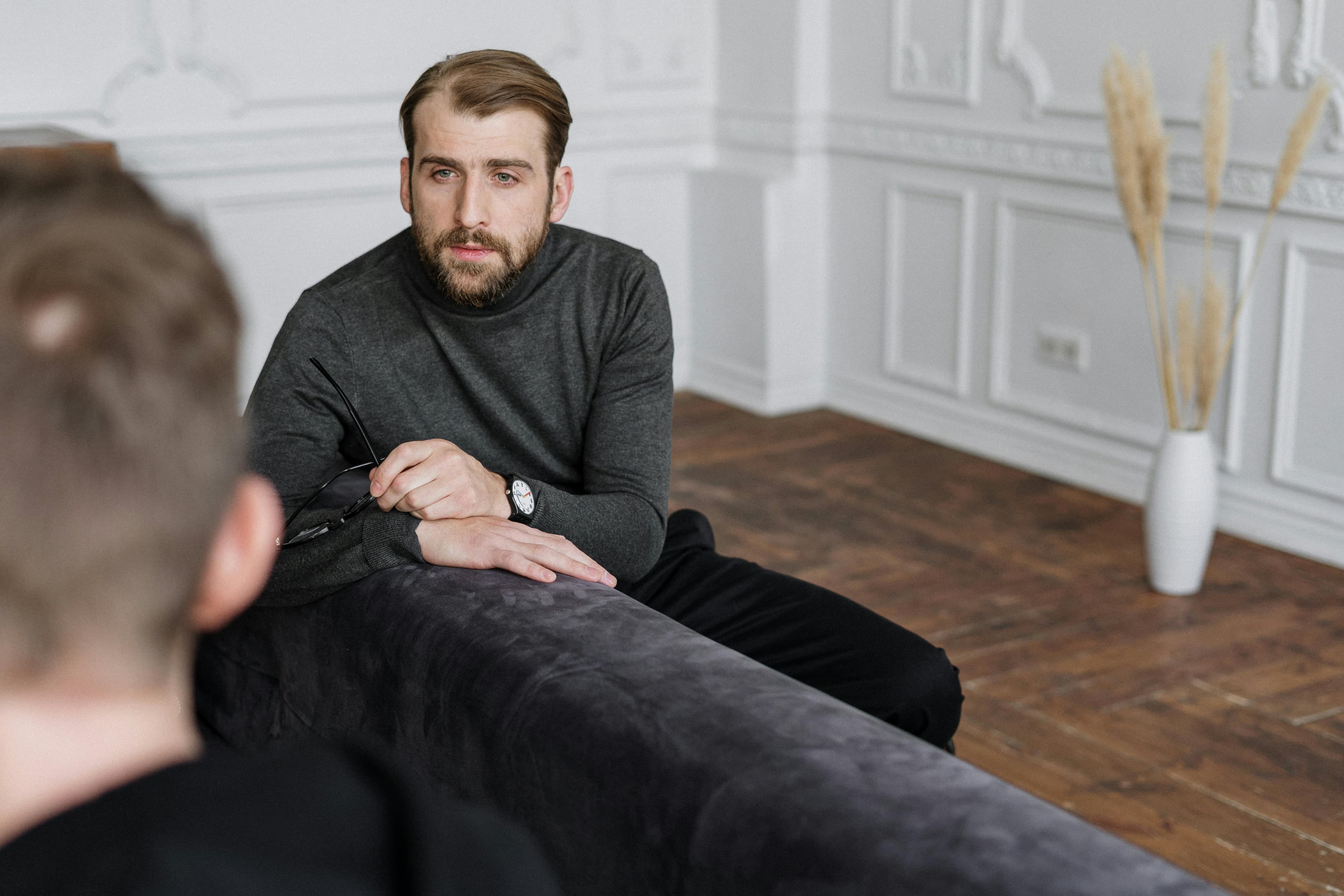 An osteopath consulting with a patient in a clinical setting