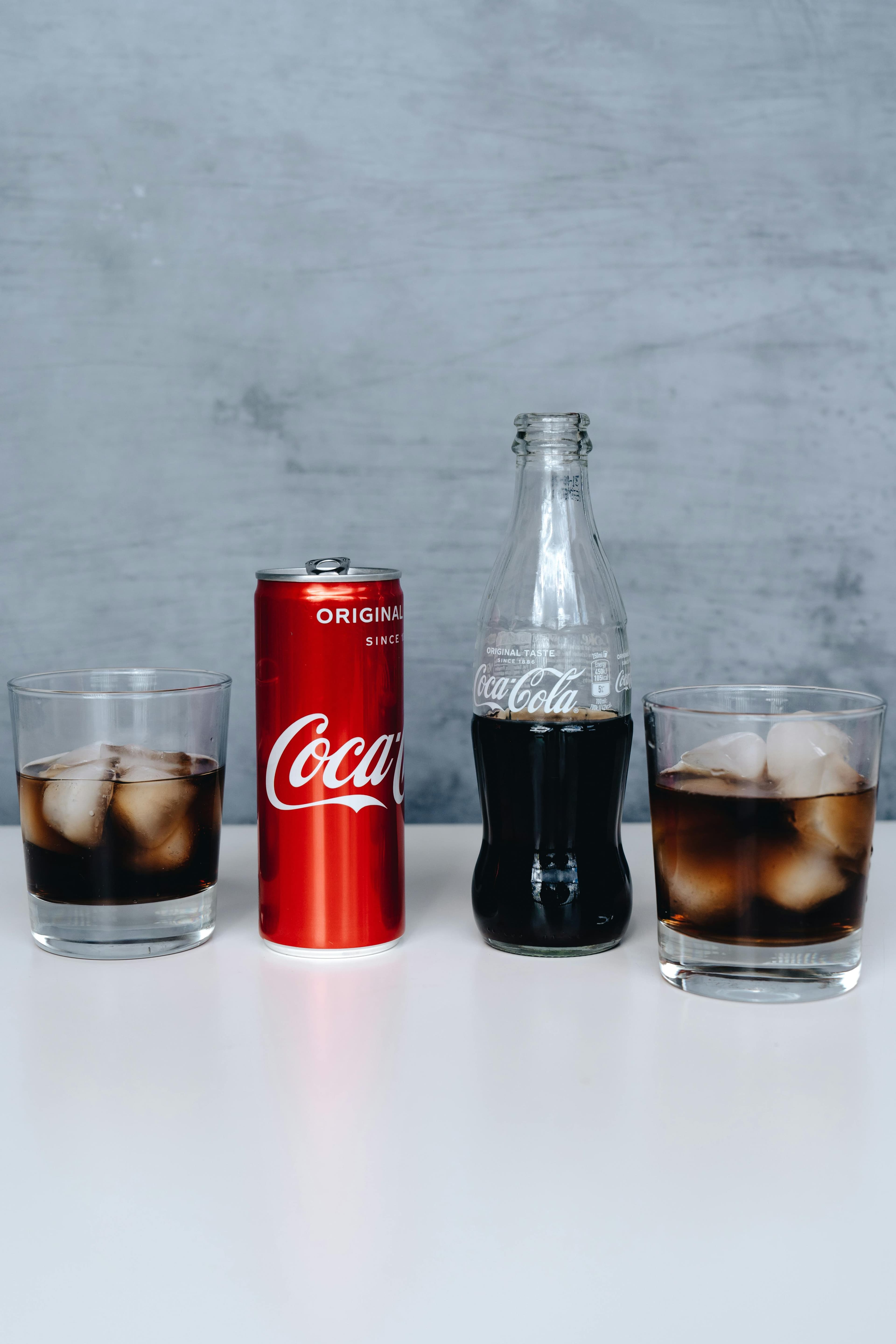 A can of Diet Coke next to a glass filled with ice and the beverage