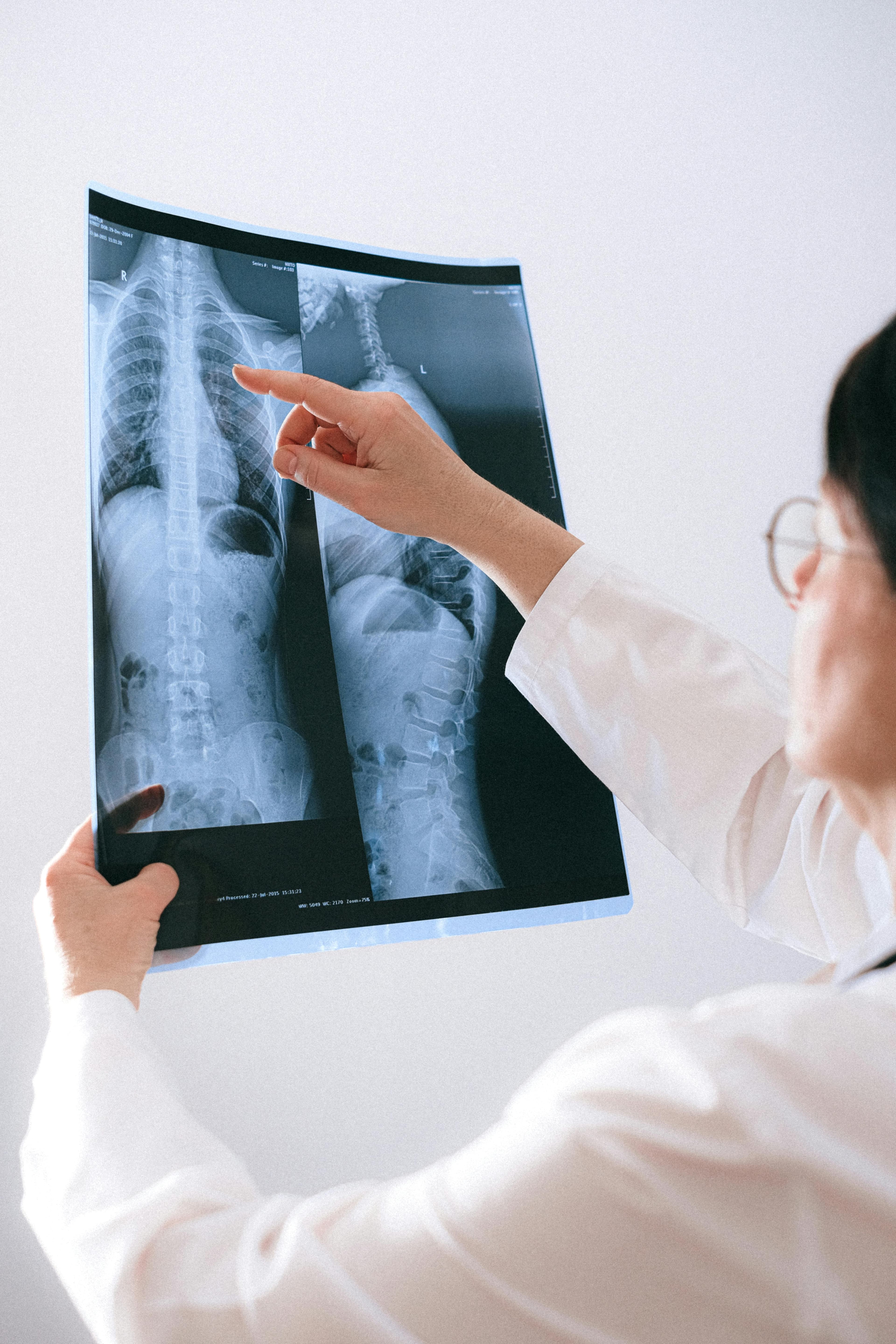 Doctor examining patient's spine for lower back issues