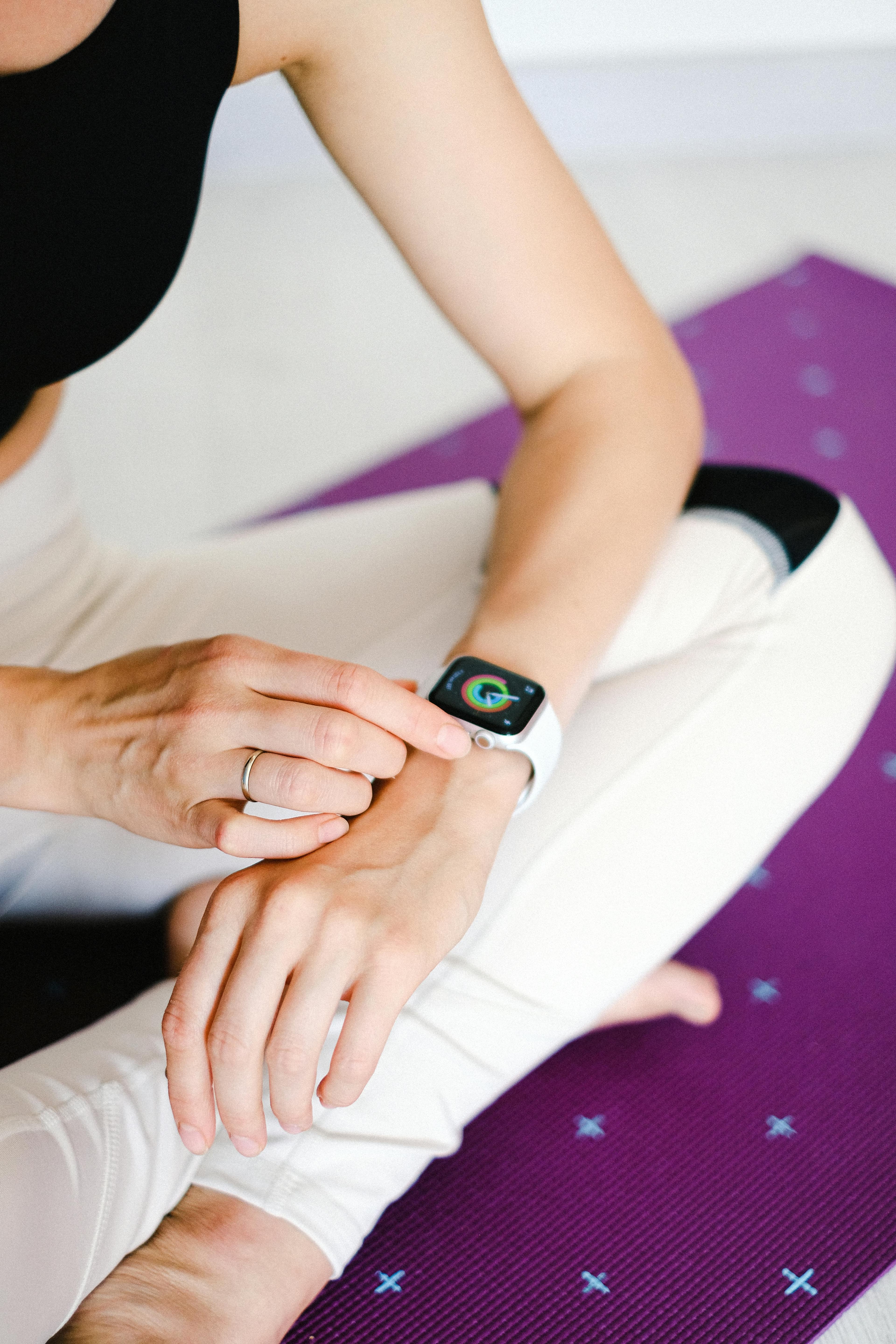 A person wearing a continuous glucose monitoring device on their arm