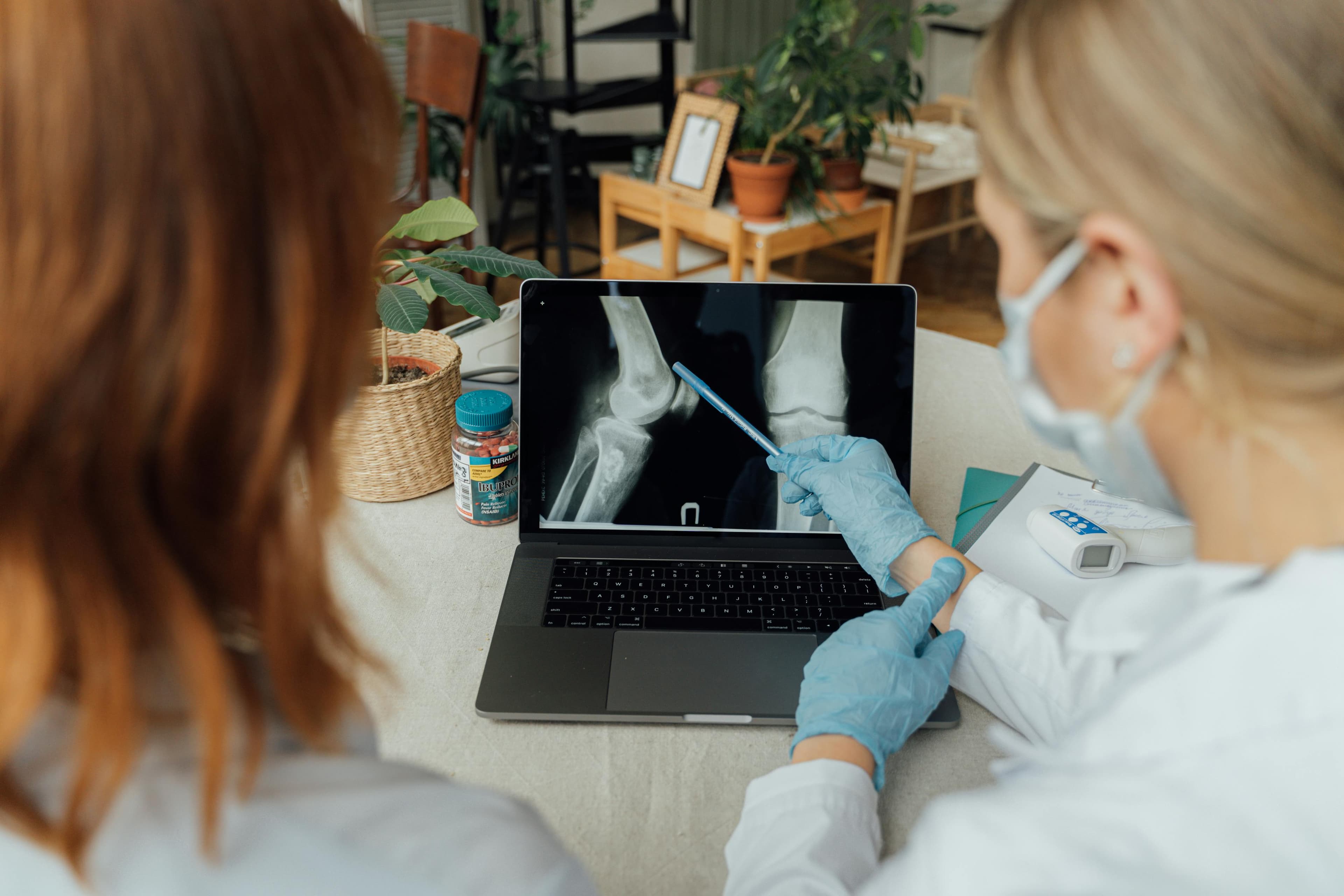 A doctor examining x-rays of joints affected by rheumatoid arthritis