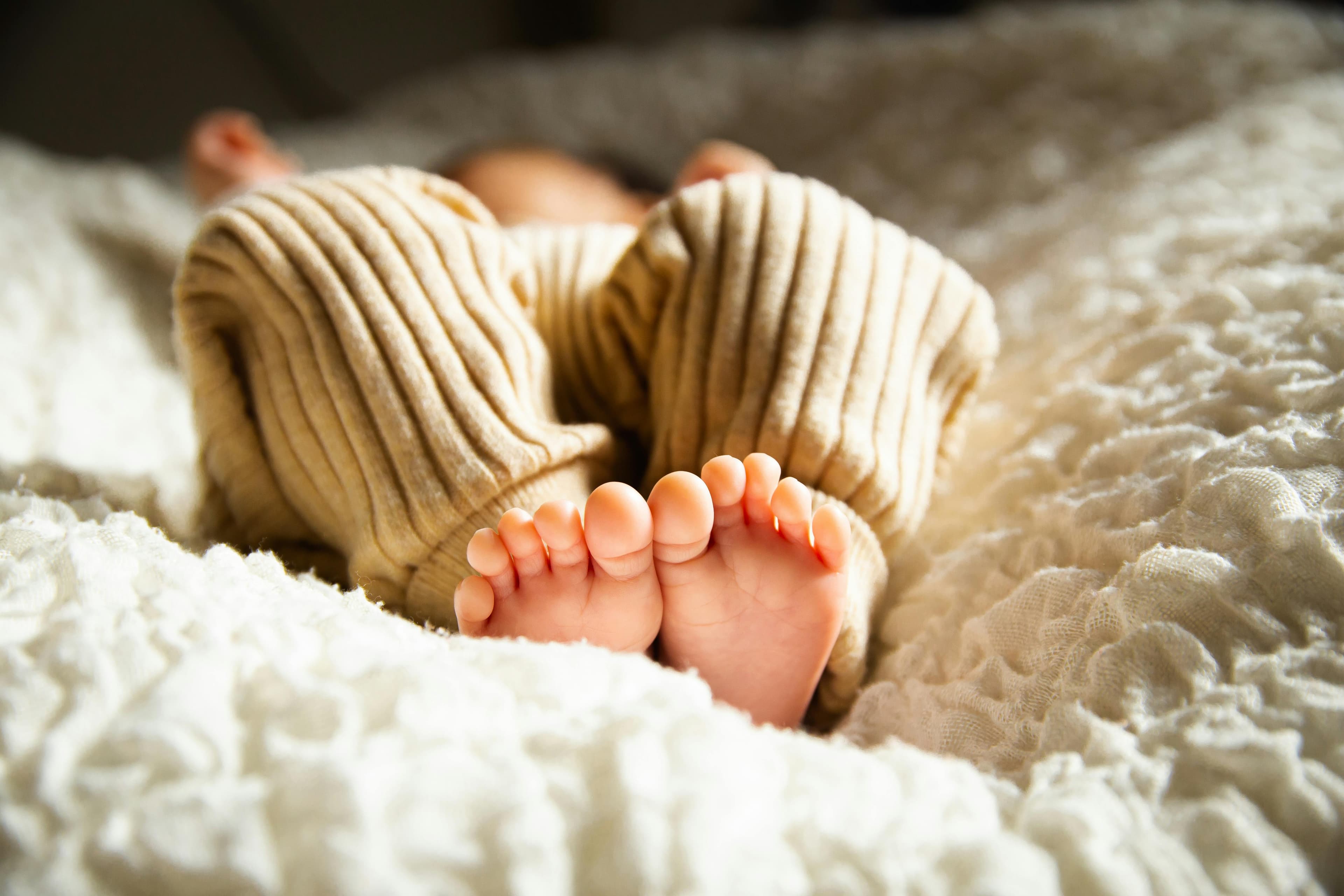 A peacefully sleeping baby in a crib