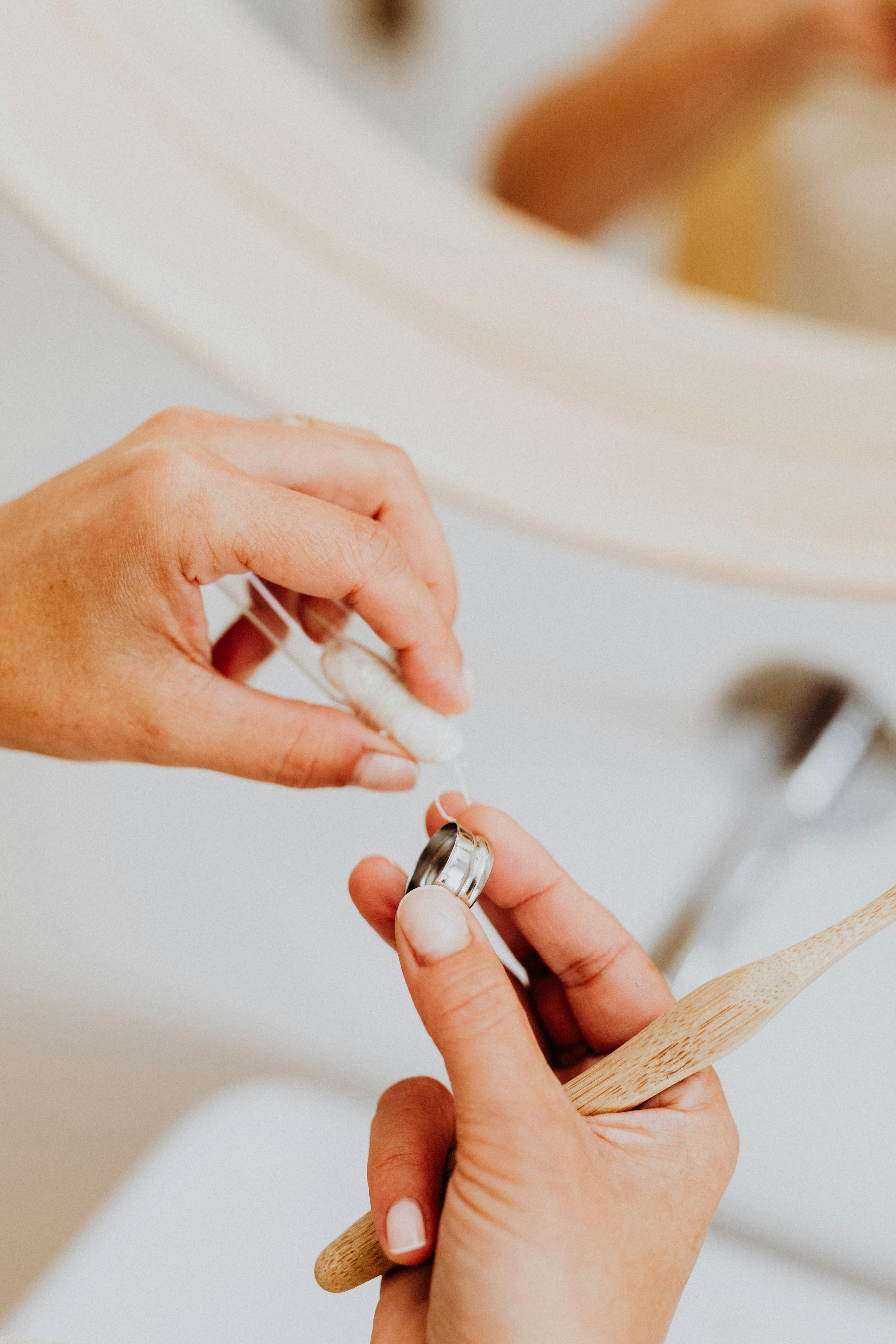 Person brushing teeth and flossing as part of good oral hygiene routine