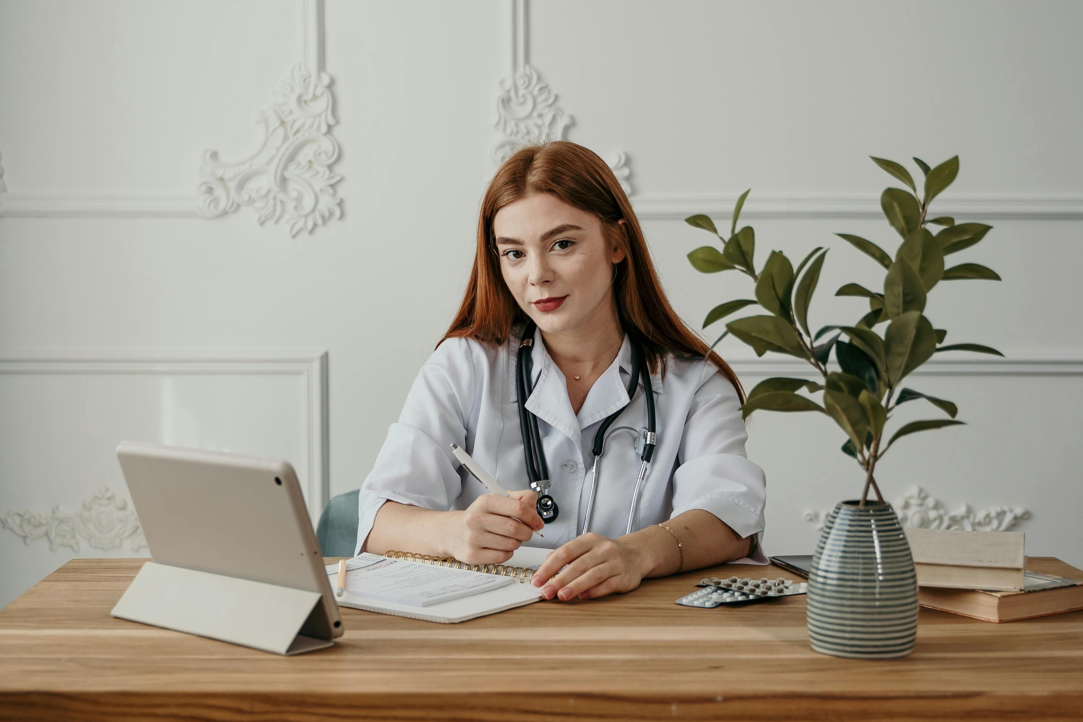 A healthcare professional studying ECGs on a tablet or laptop