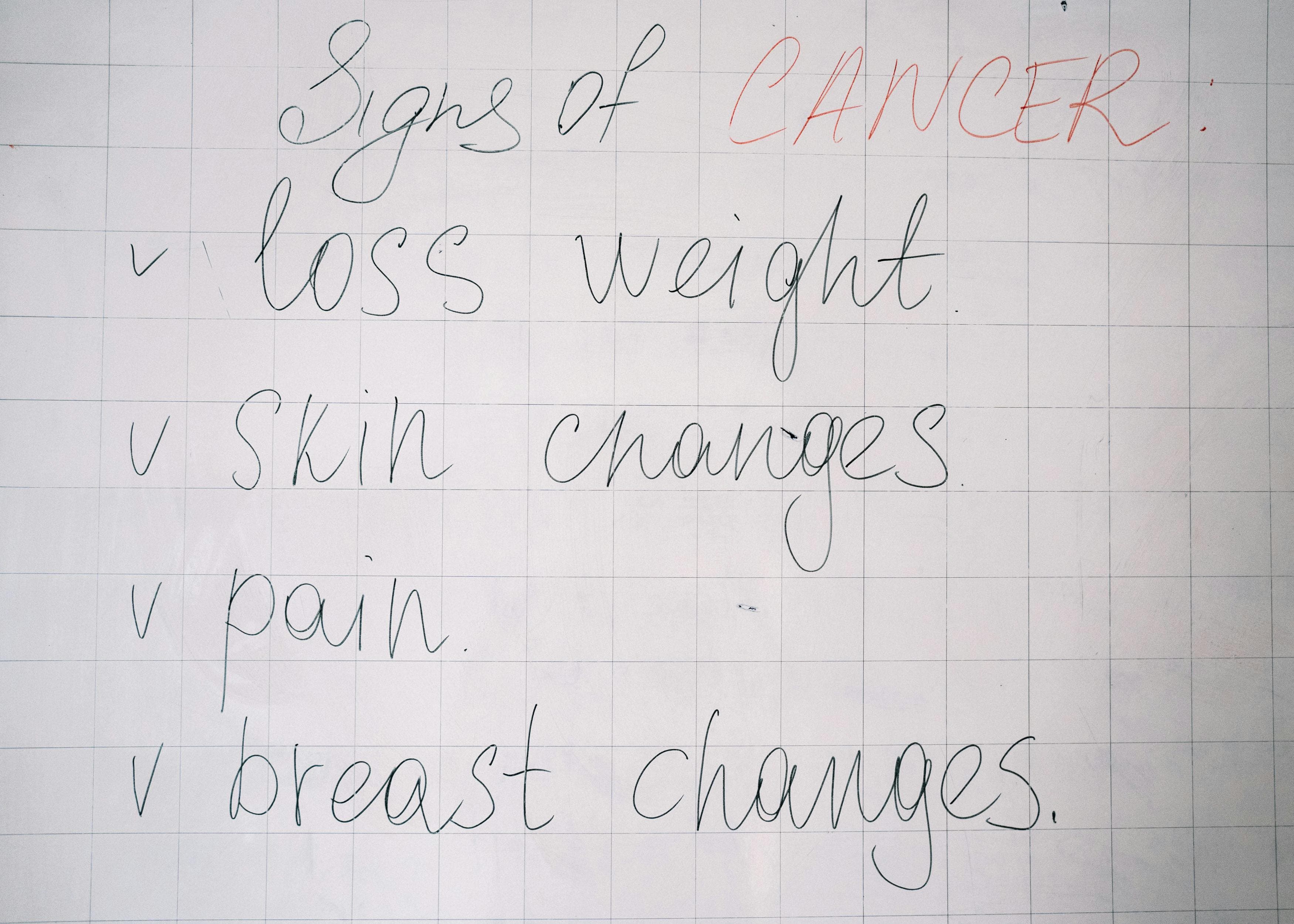 A tanning bed in a salon with warning signs about skin cancer risks