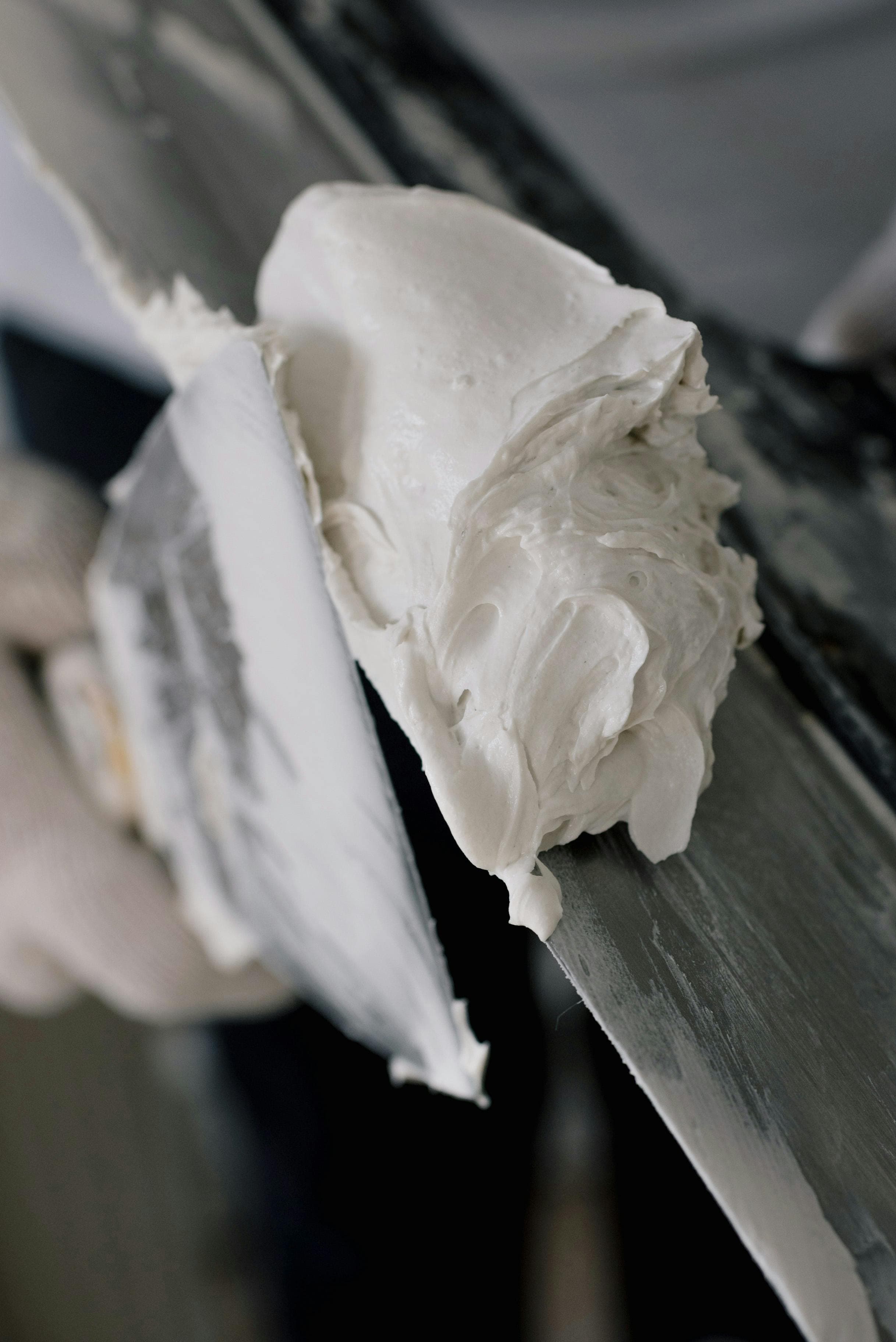 A surgeon performing a cemented knee replacement, showing the application of bone cement
