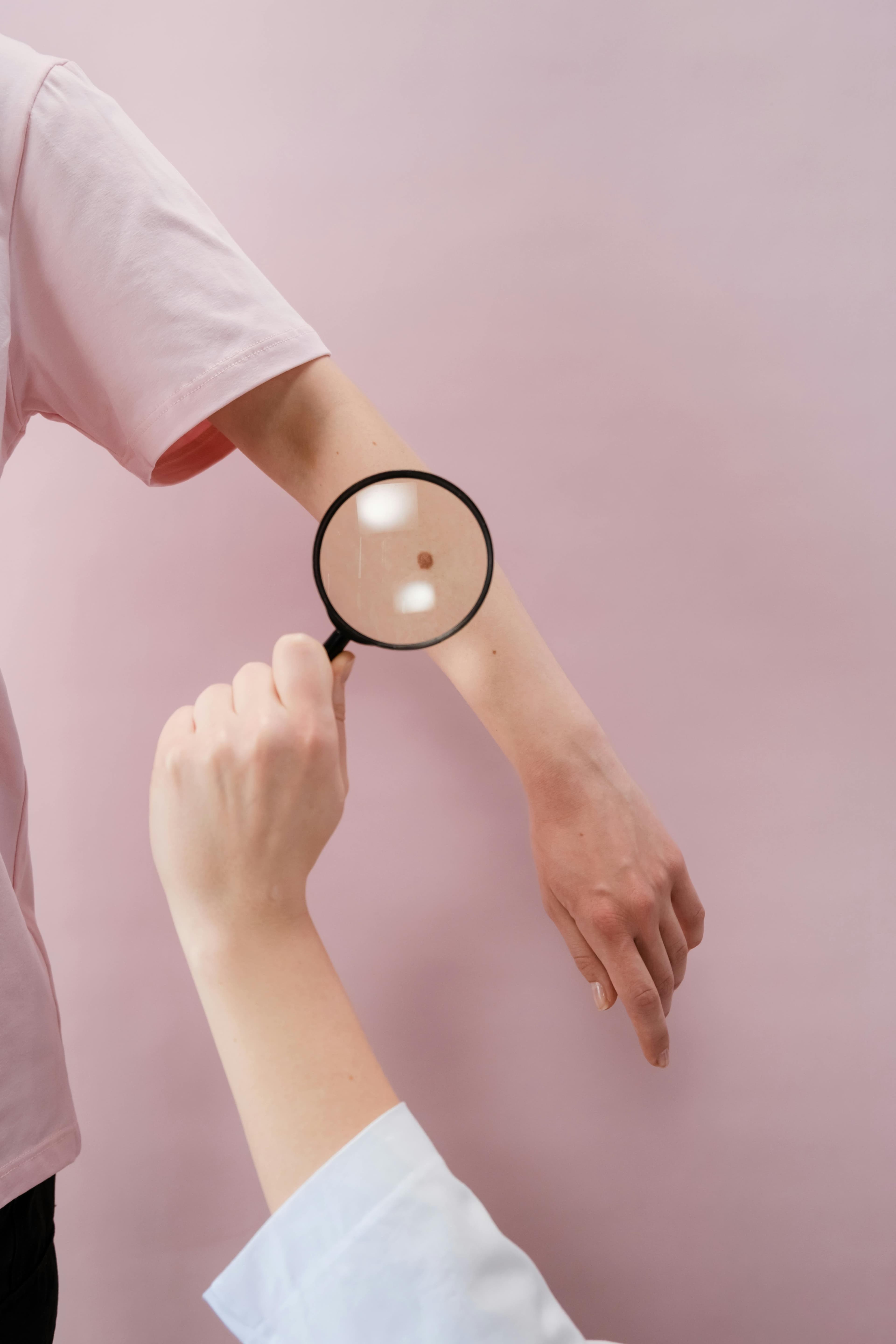 Dermatologist examining patient's skin for signs of skin cancer