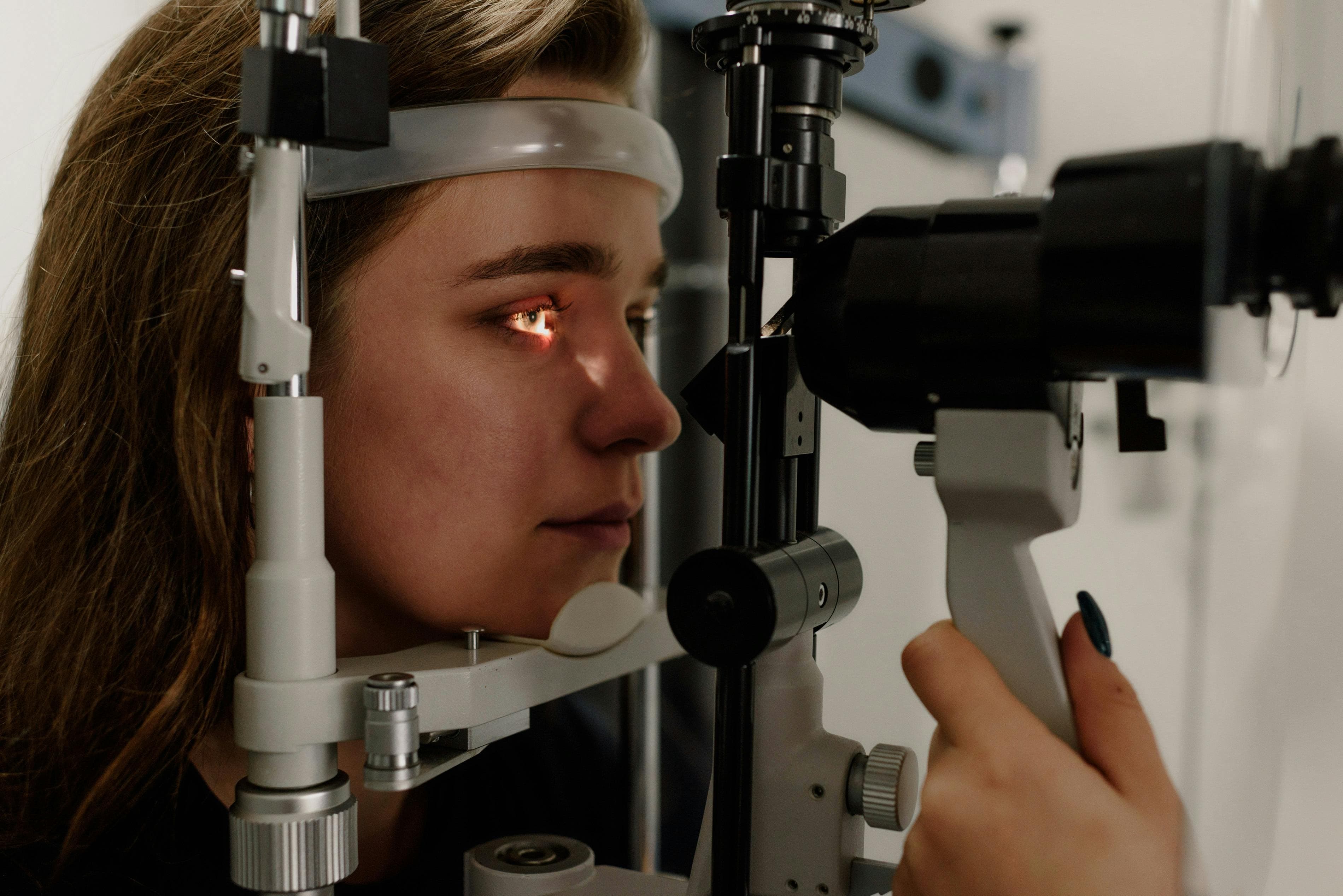 Ophthalmologist performing a slit-lamp examination of a patient's eyelids