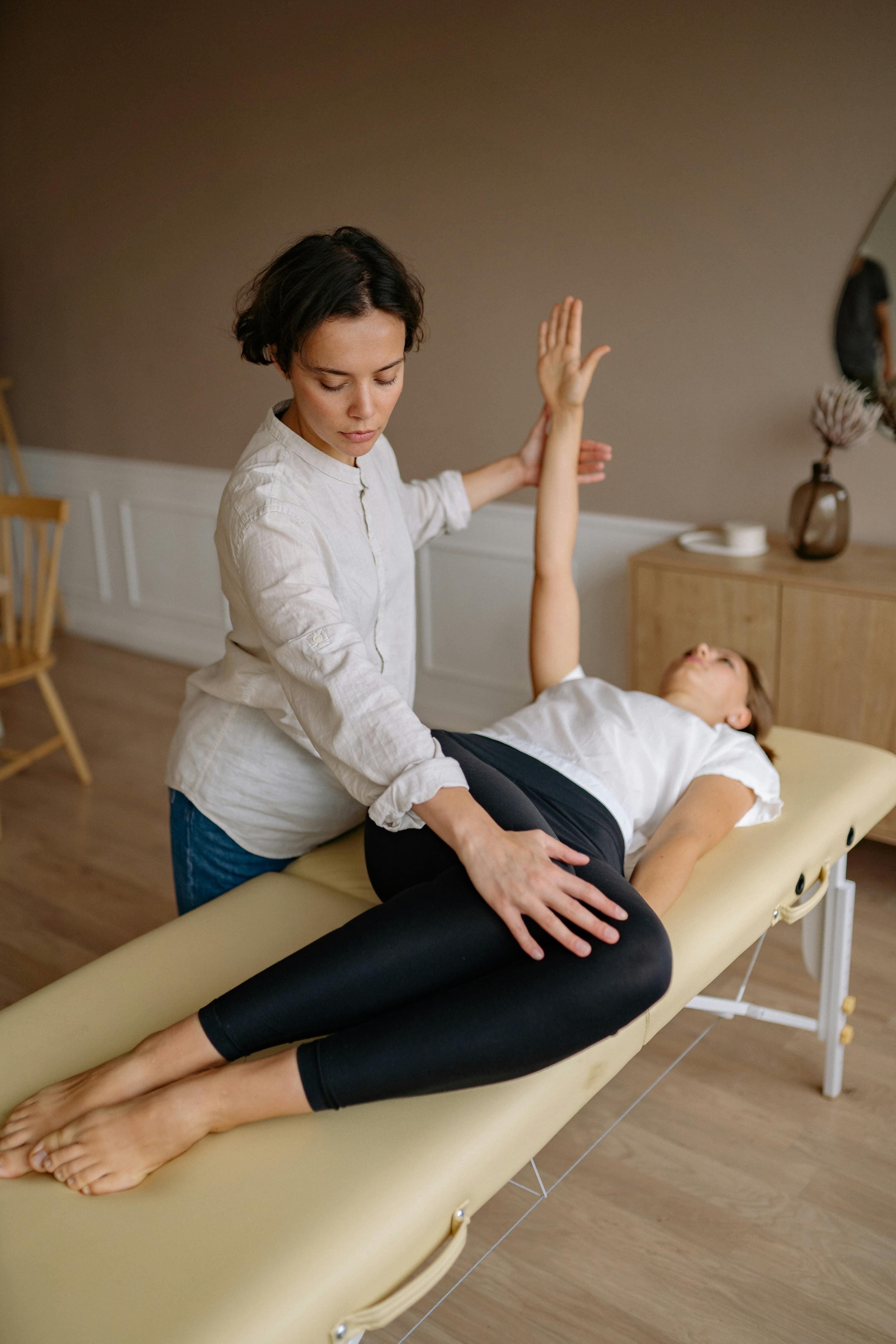 A physiotherapist guiding a patient through exercises after hip replacement surgery