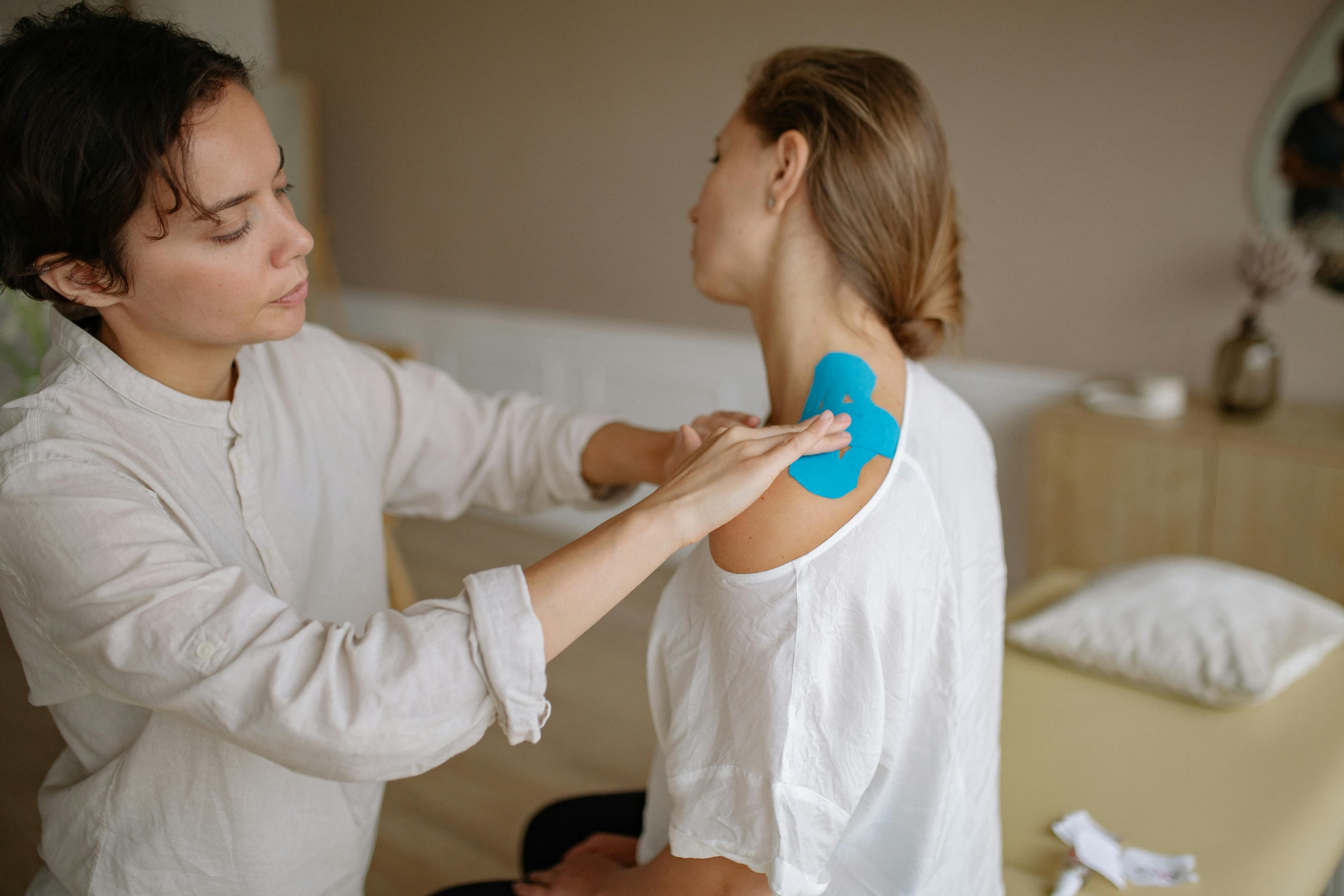 A physiotherapist performing dry needling on a patient's shoulder