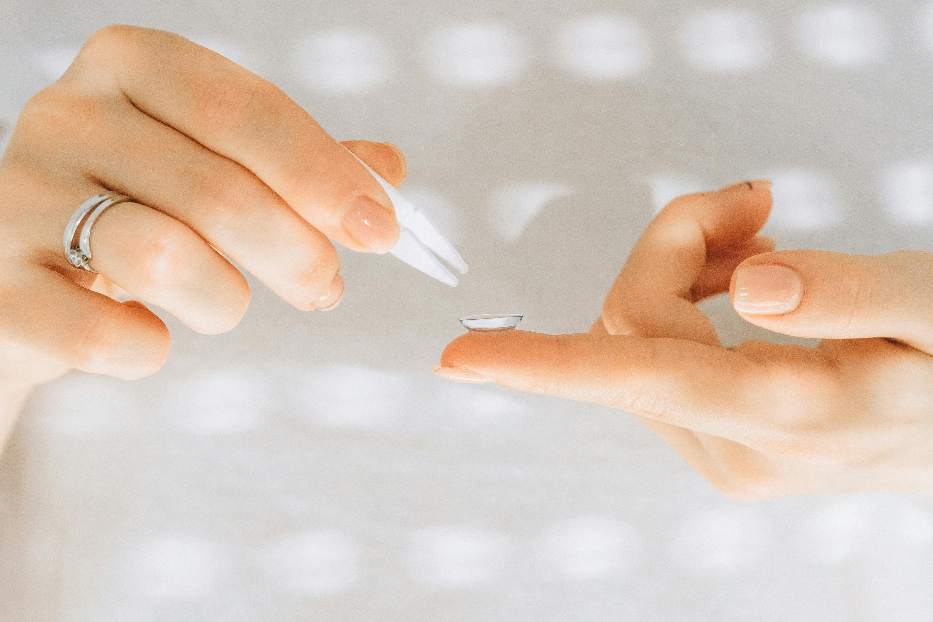Ophthalmologist removing corneal transplant sutures