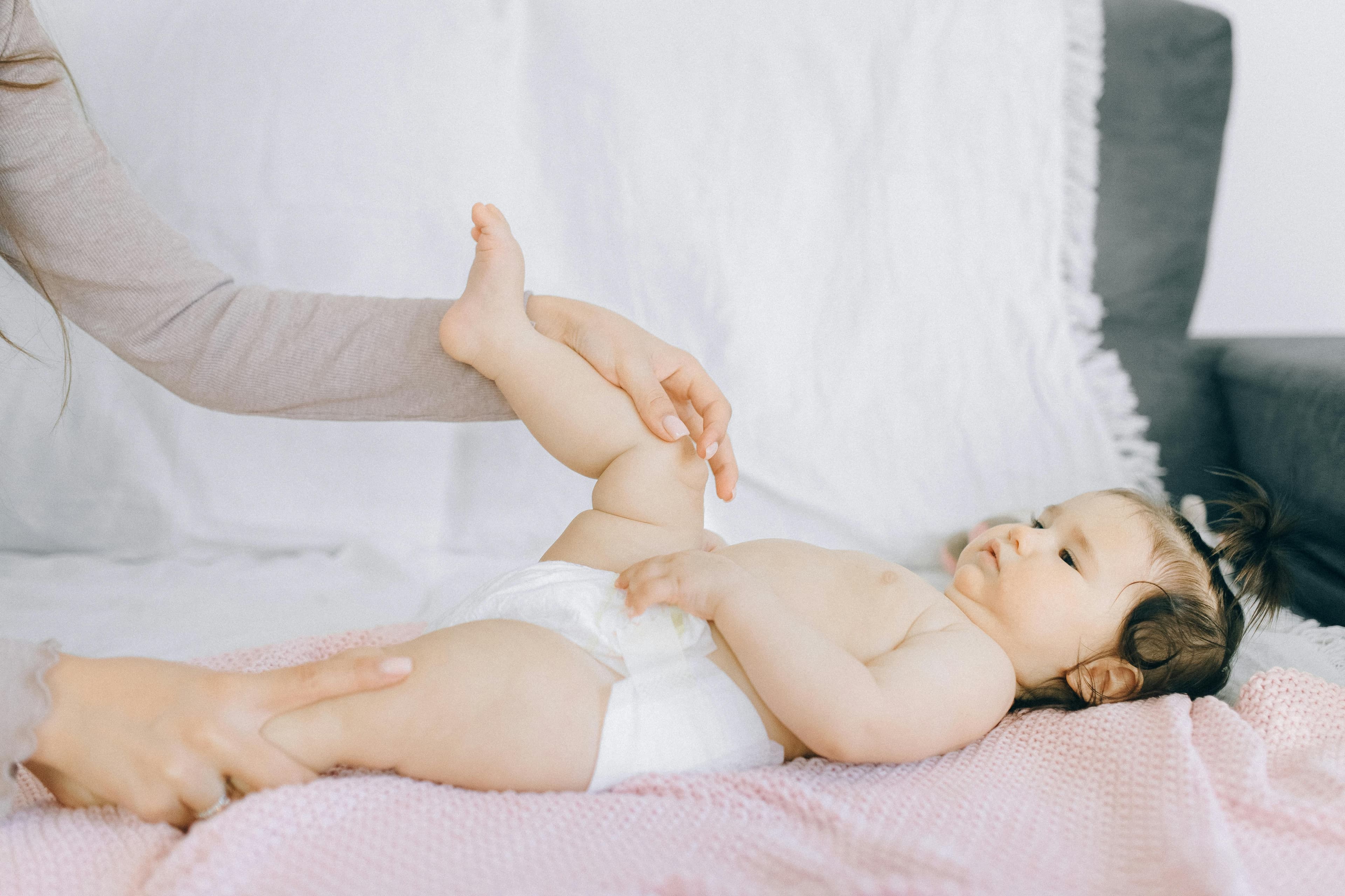 A baby coughing while being comforted by a parent