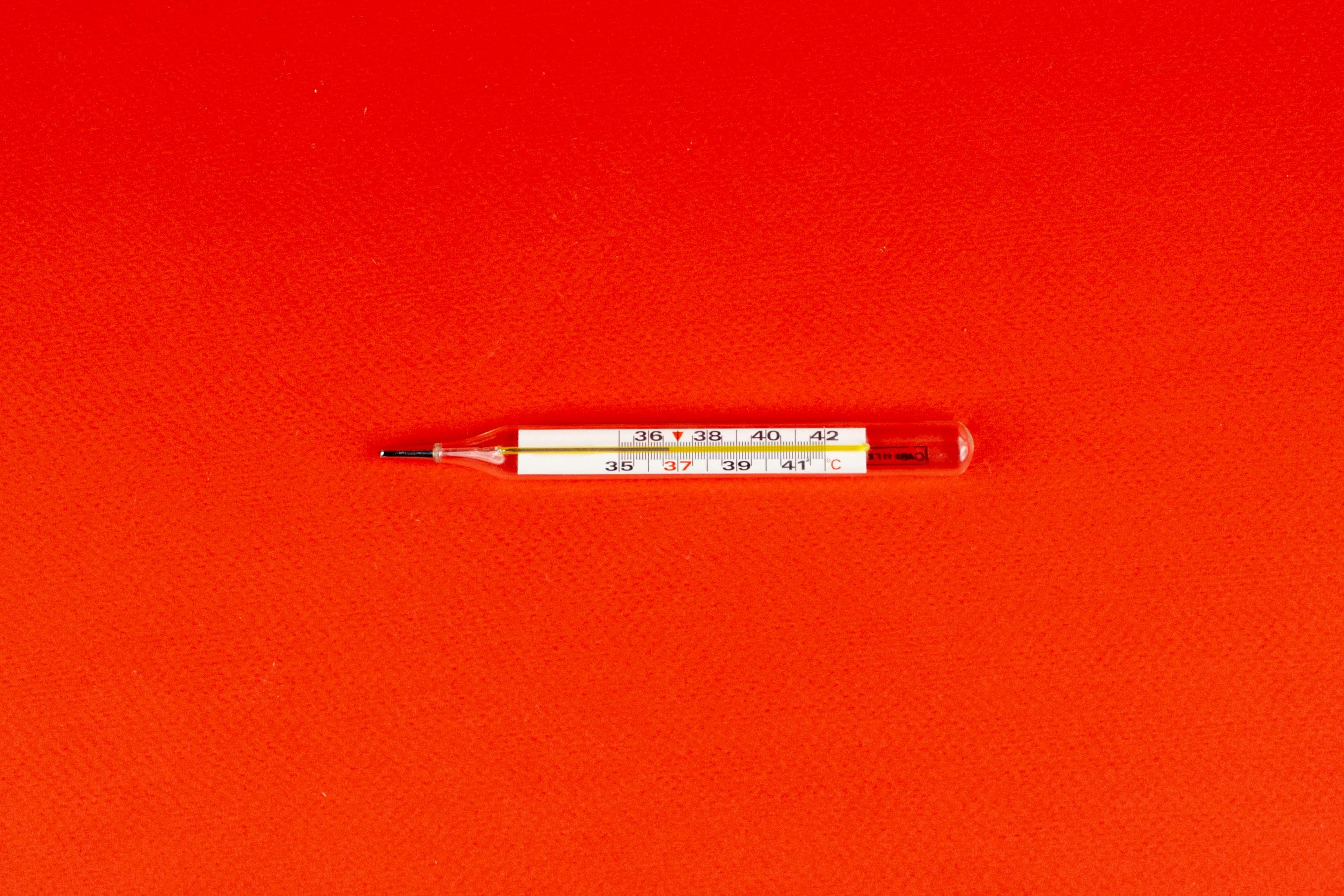 A digital thermometer showing a high temperature, indicating a fever