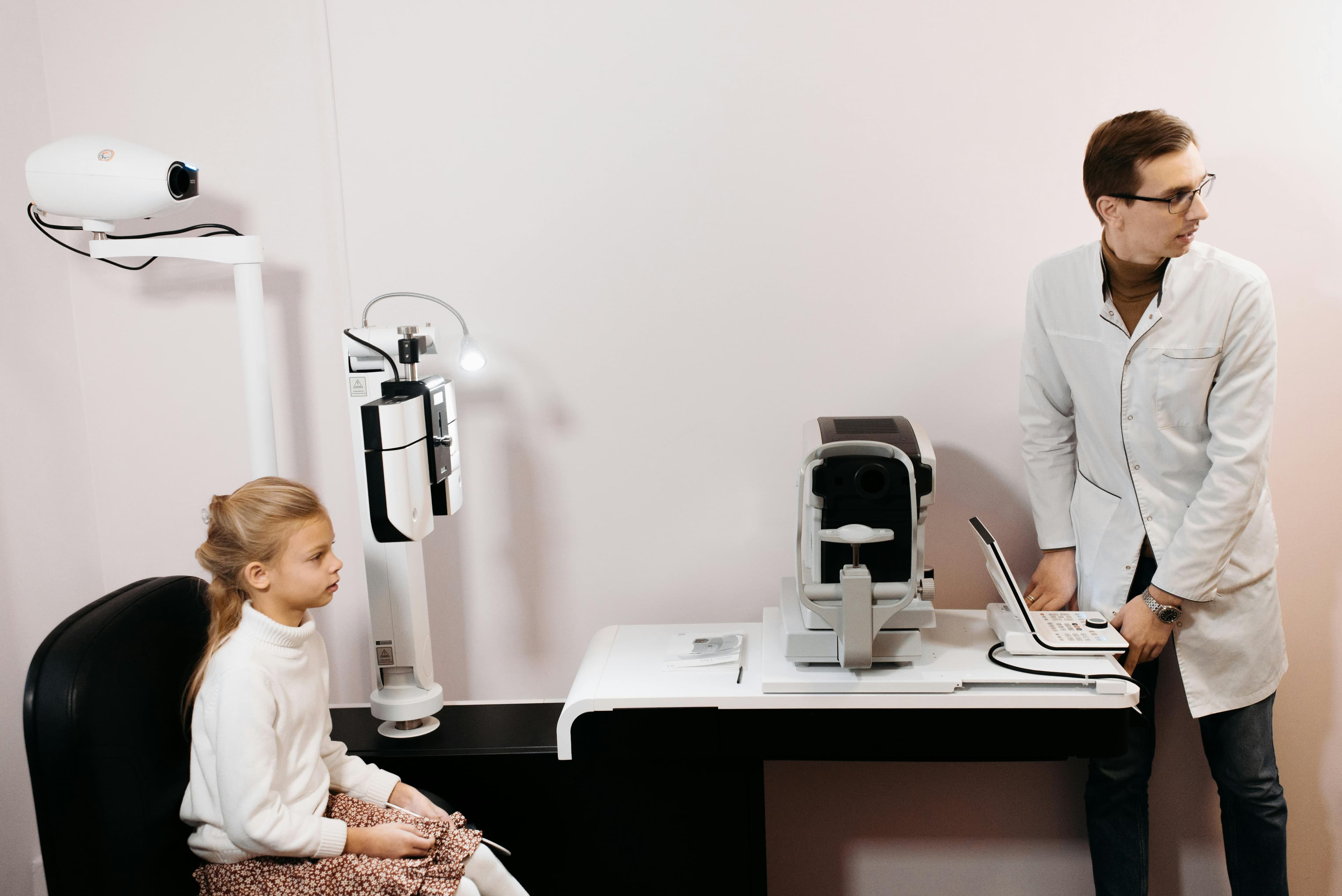 An optometrist using a digital system to conduct an eye examination