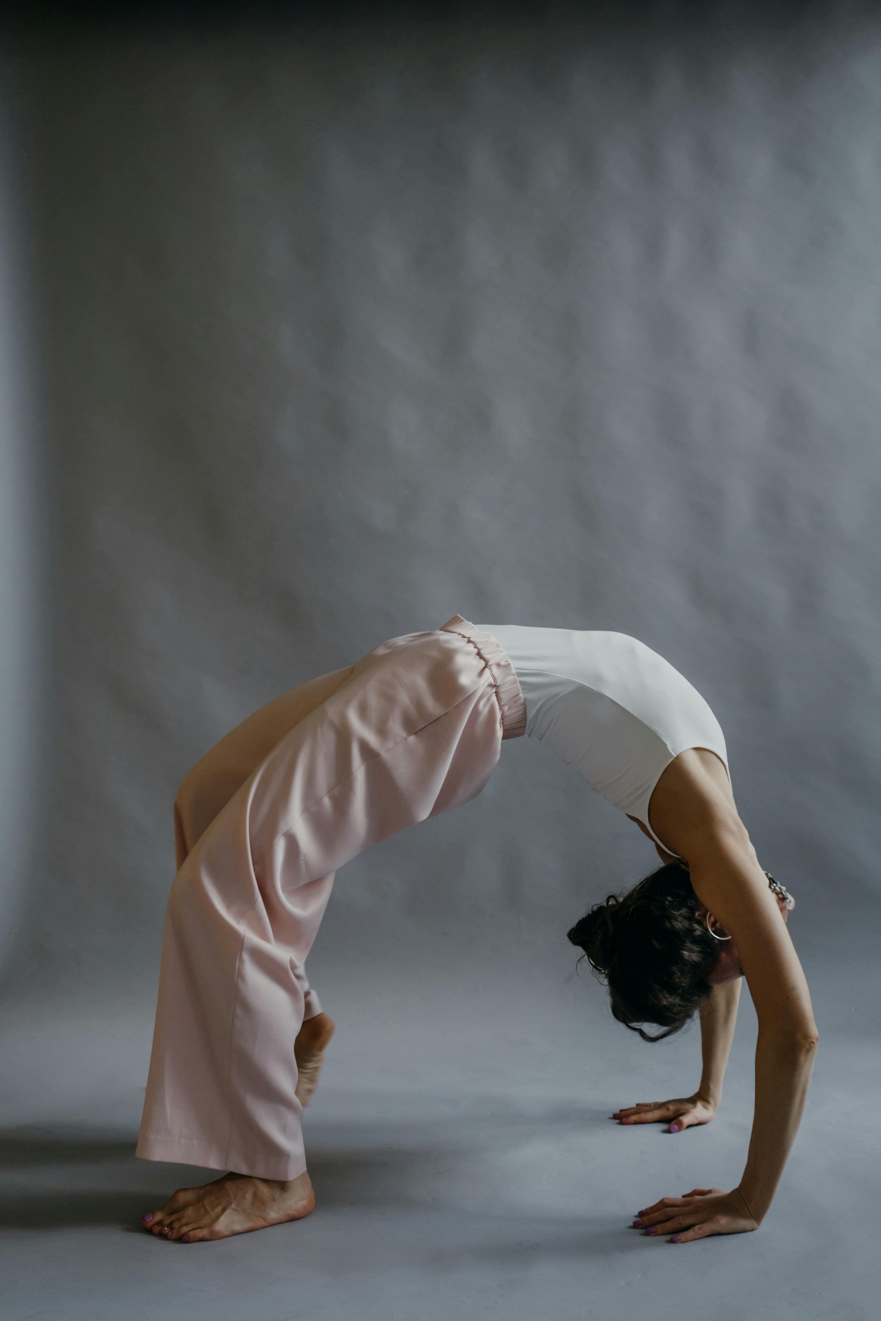 Person demonstrating a gentle jaw stretching exercise to relieve jaw cramps