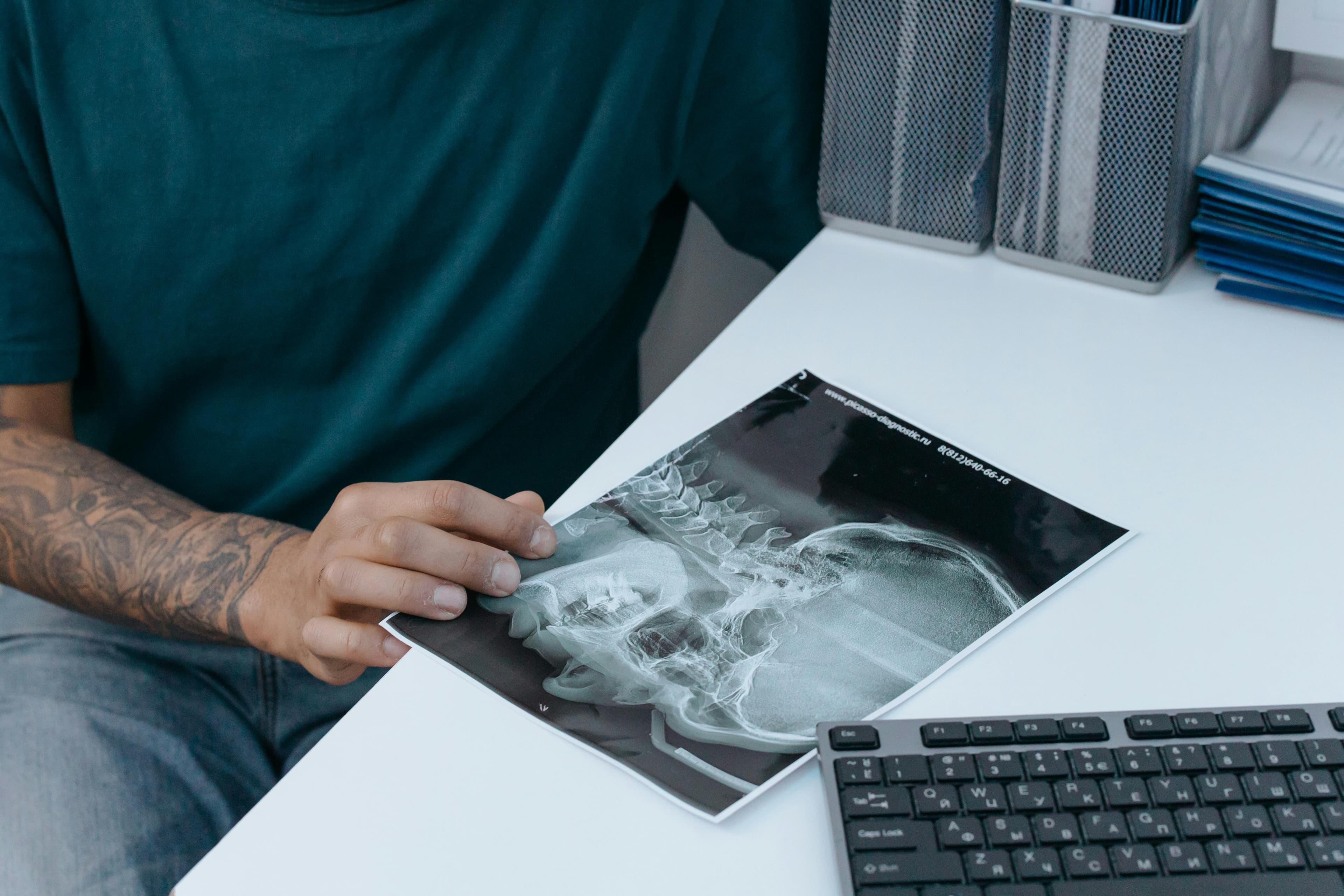 Person holding their jaw in pain, illustrating common symptoms of jaw cramps