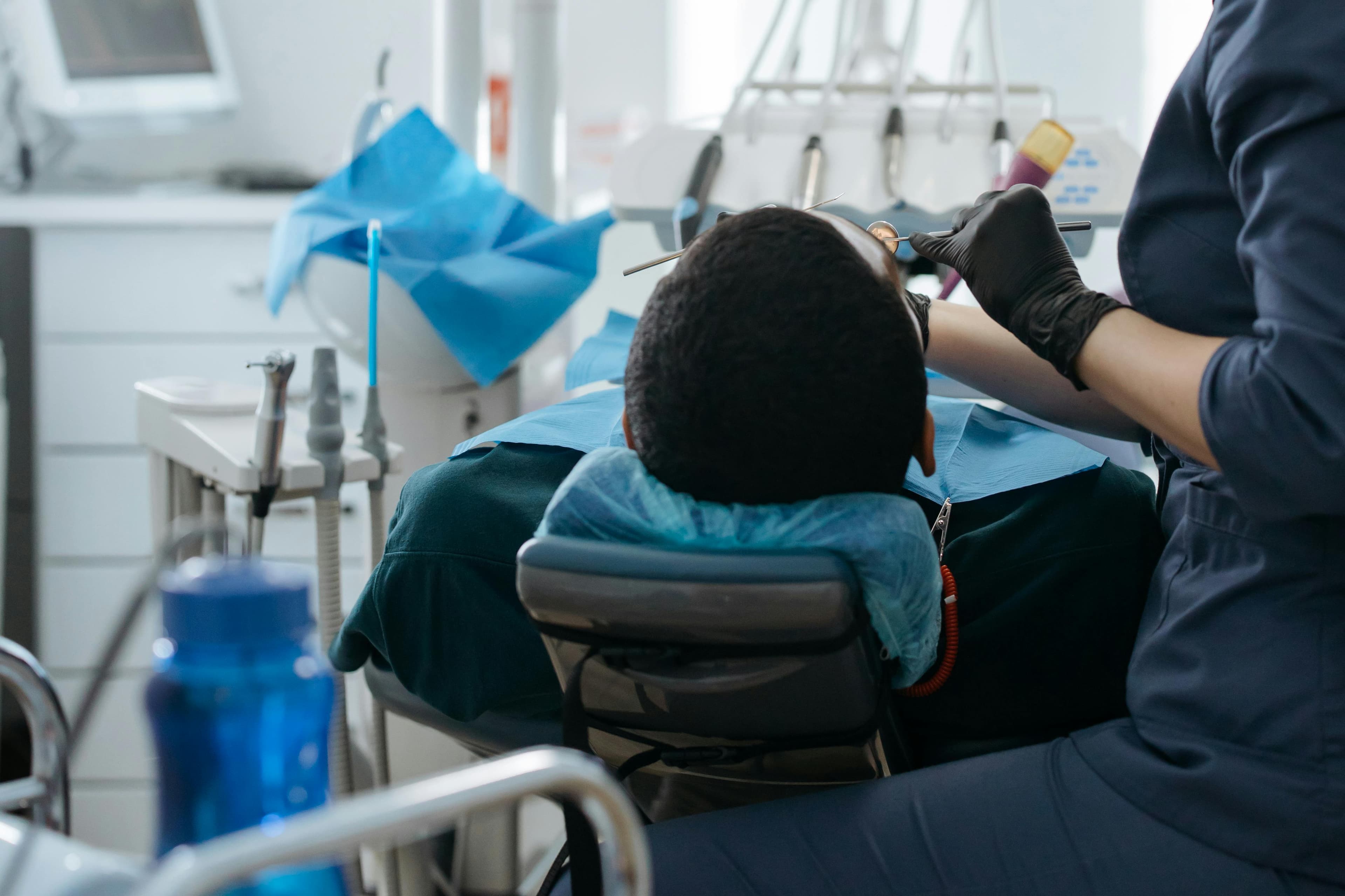 A dentist examining a patient's teeth during a routine checkup