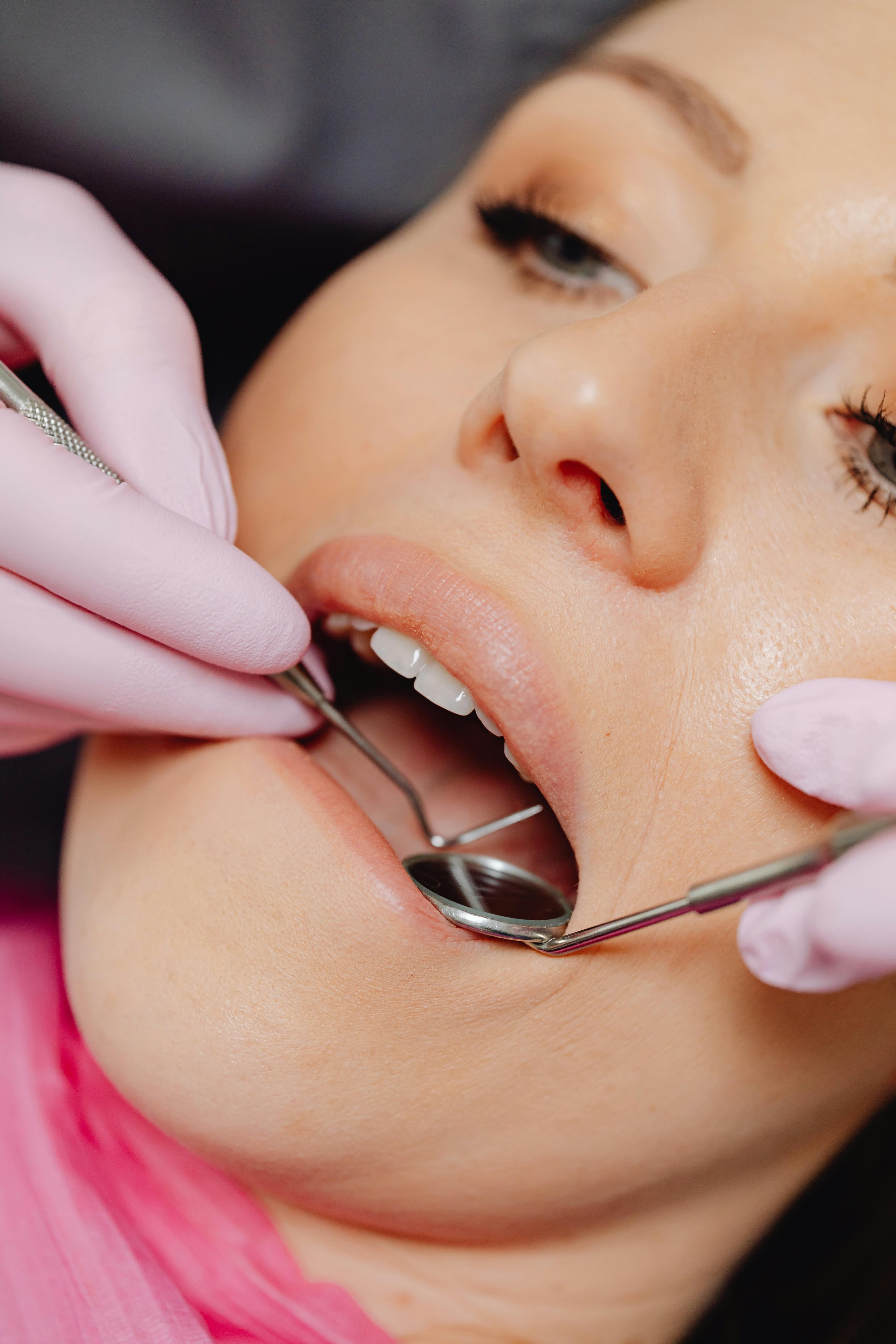Dentist performing a professional dental cleaning to prevent gum infections