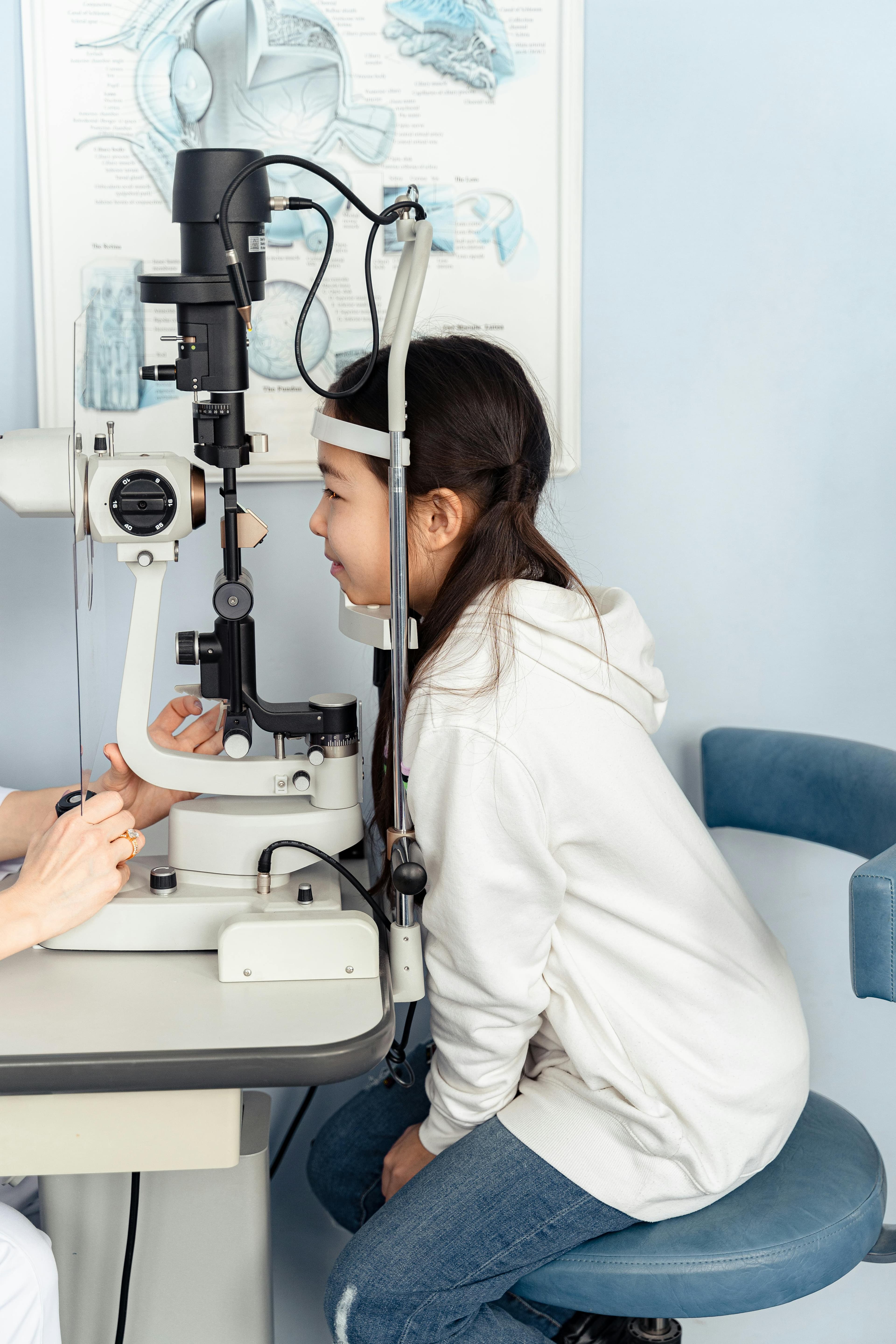 An optometrist examining a patient's eyes using a slit lamp