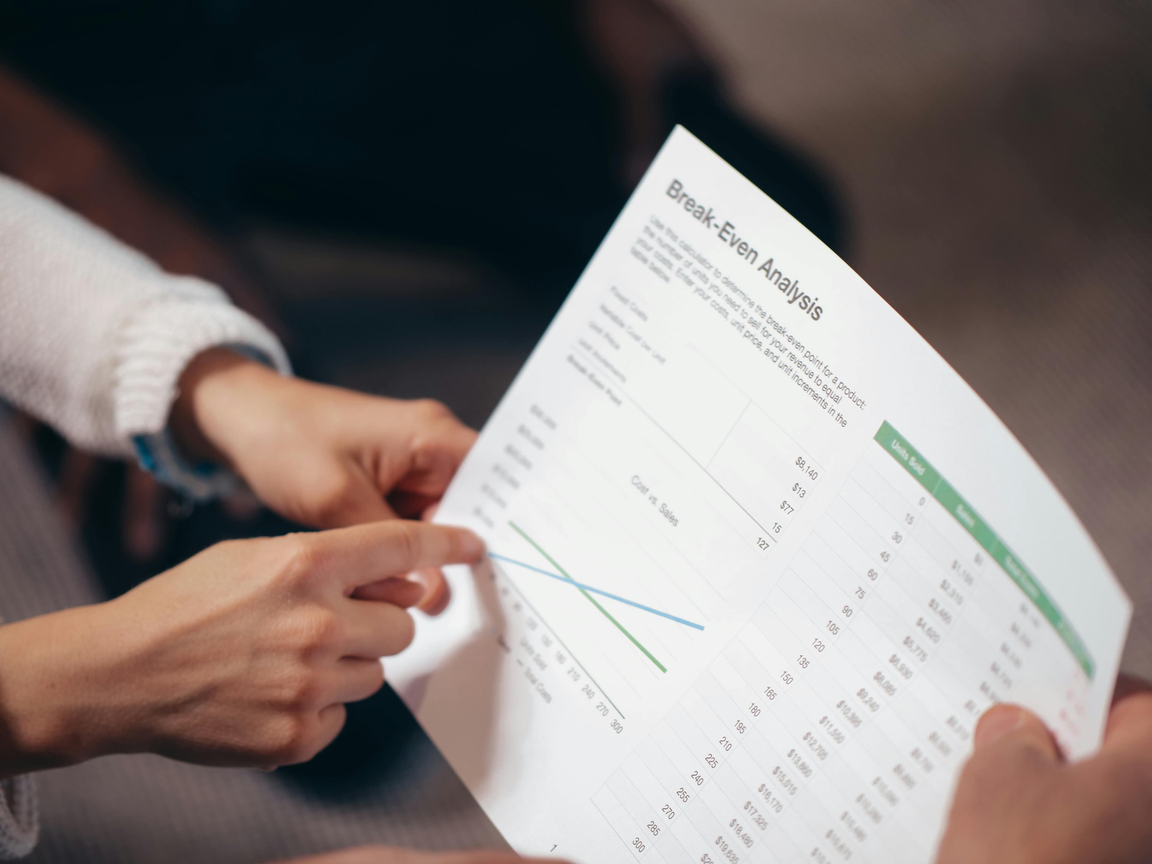 A healthcare provider discussing an eczema action plan with a patient, pointing to different sections of the document