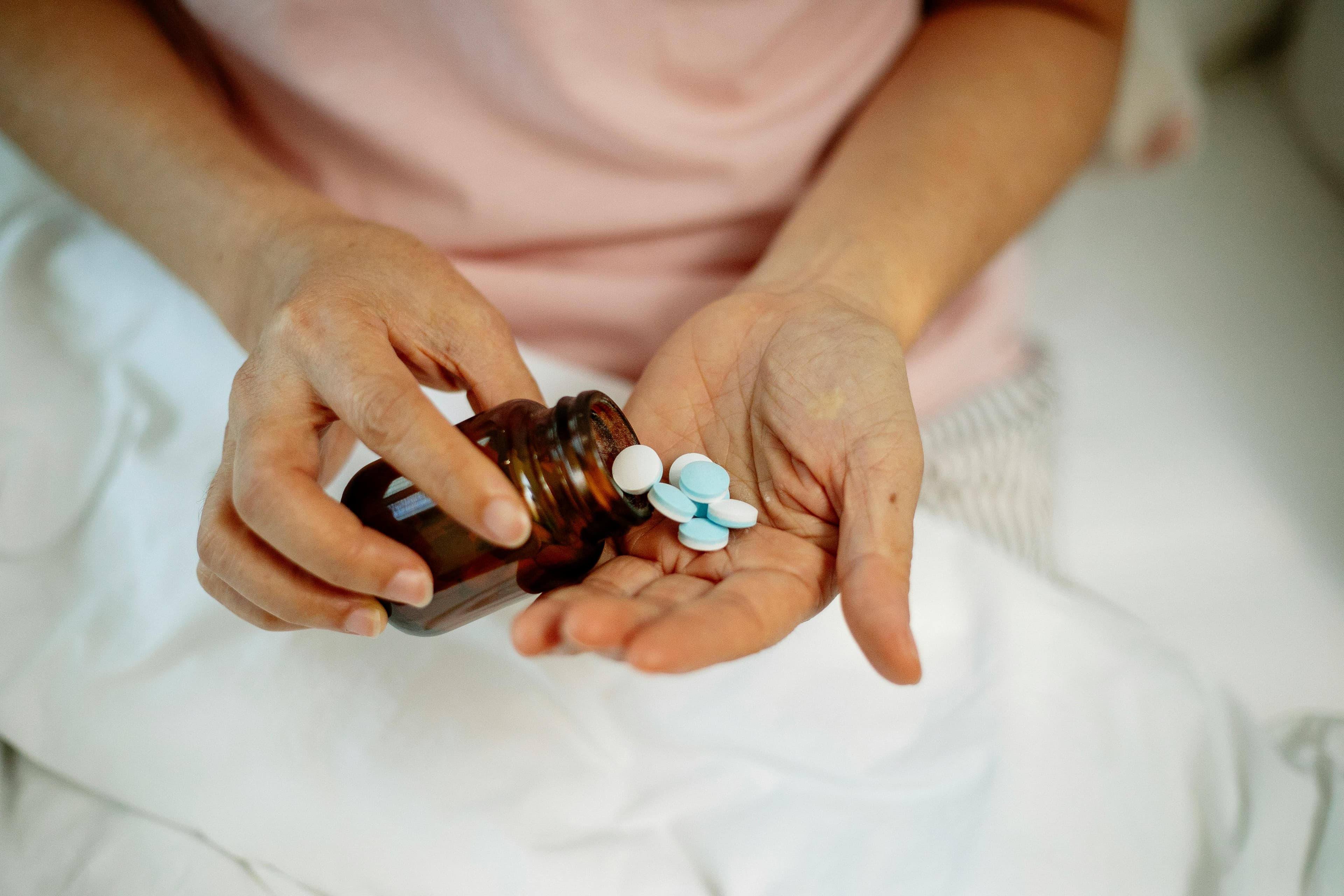 A bottle of antibiotic eye drops next to a prescription pad