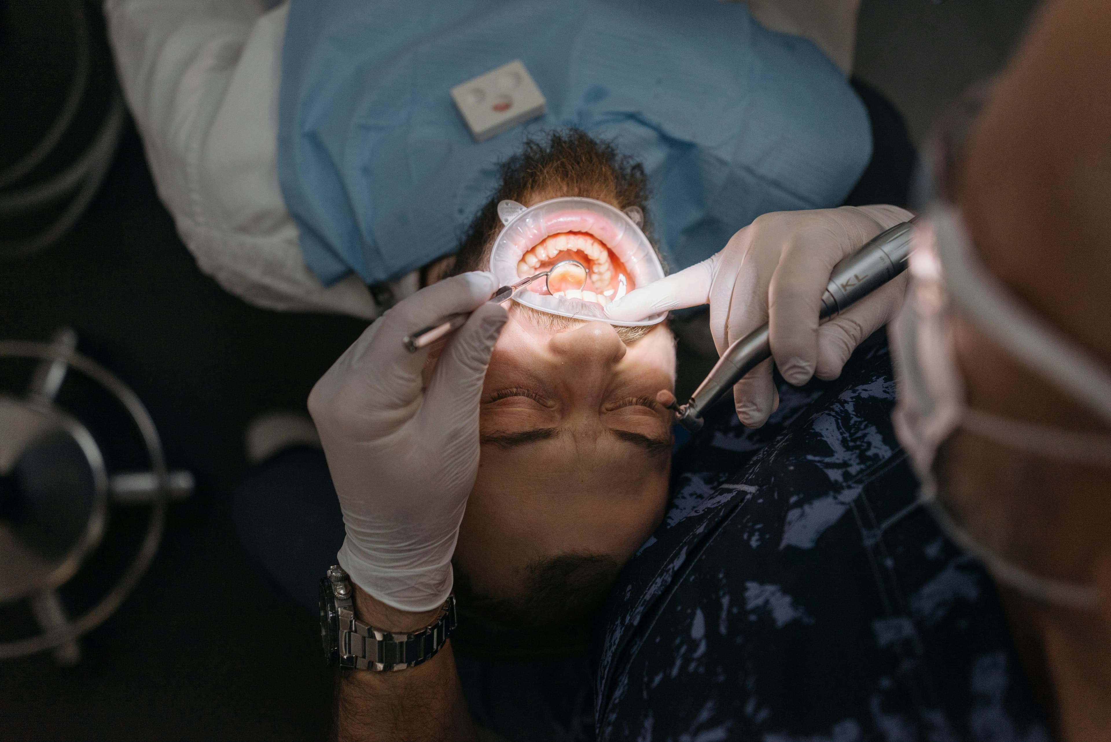 A medical professional examining an infant's mouth