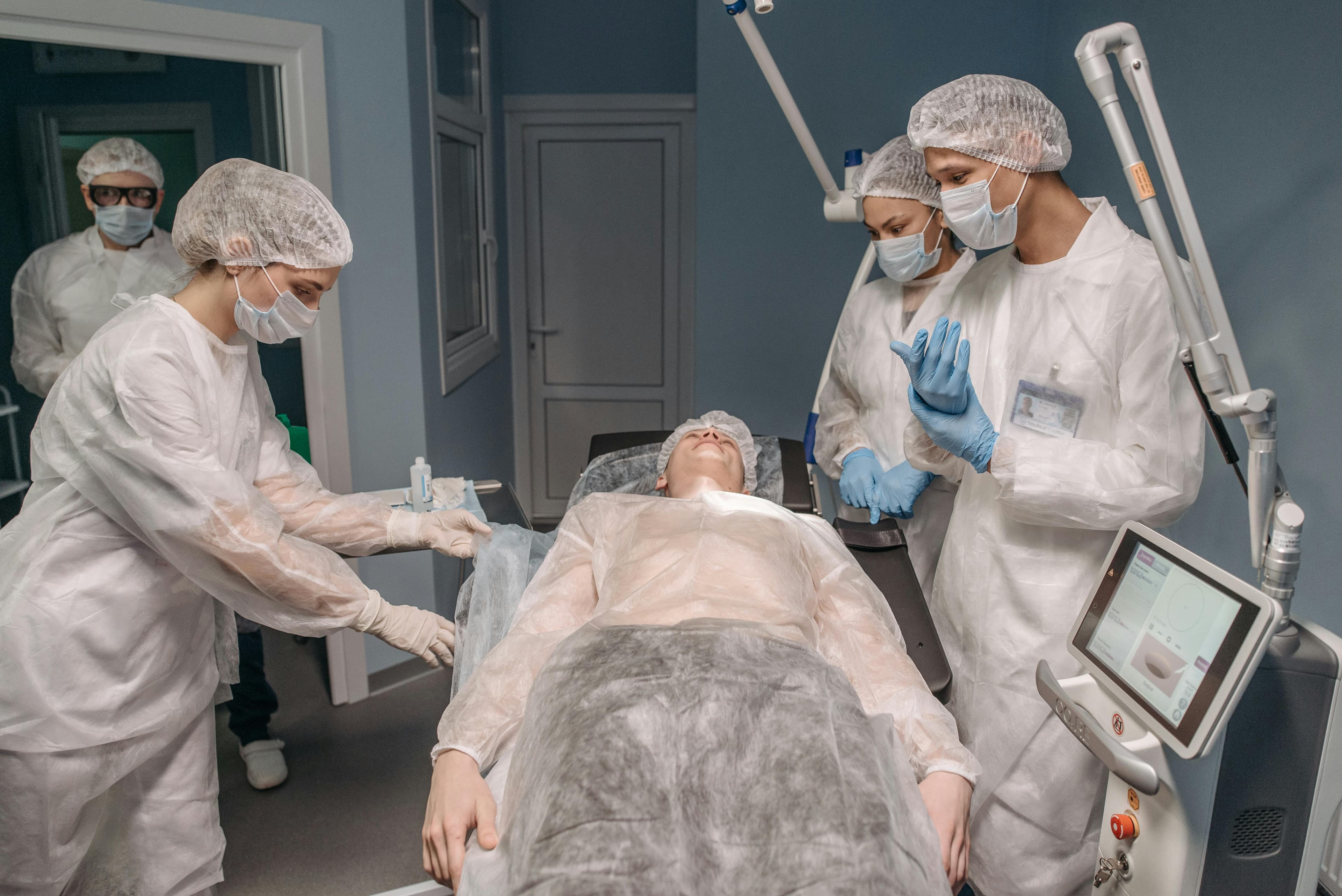 Surgeon performing ganglion cyst removal on a patient's wrist