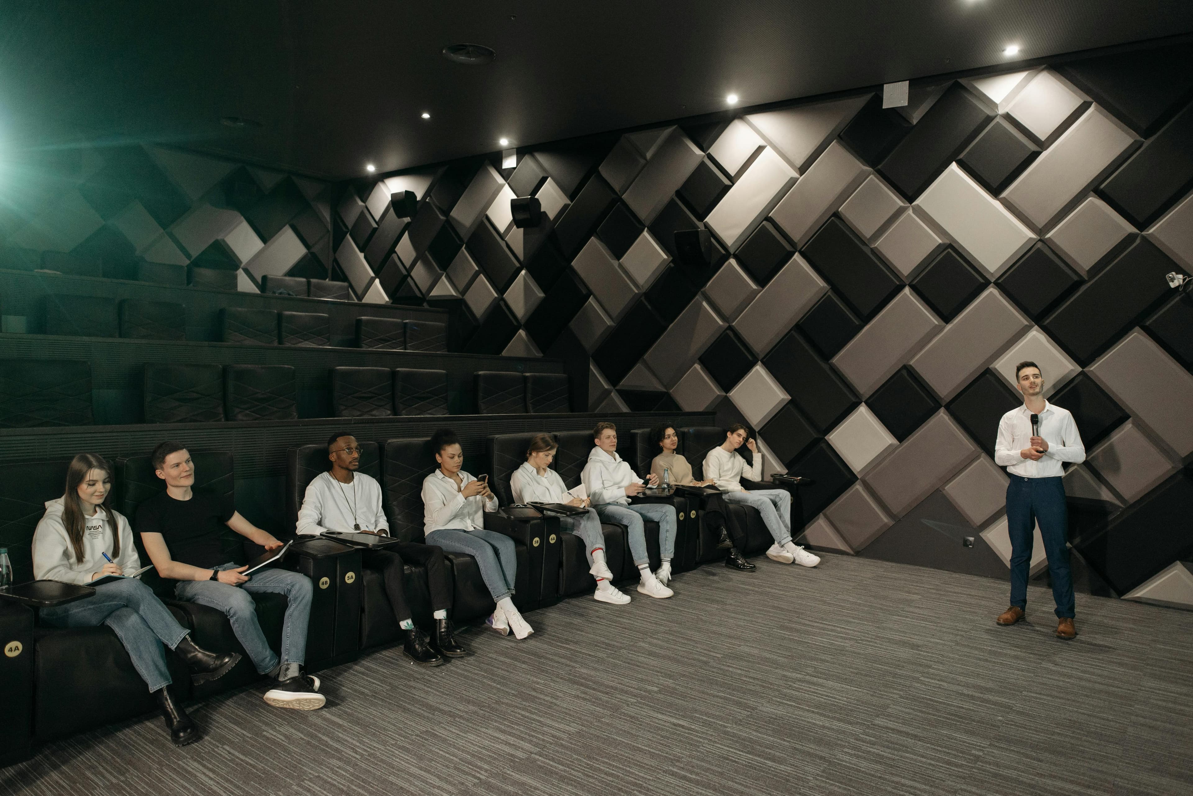 A medical professional giving a lecture to a group of students in an auditorium