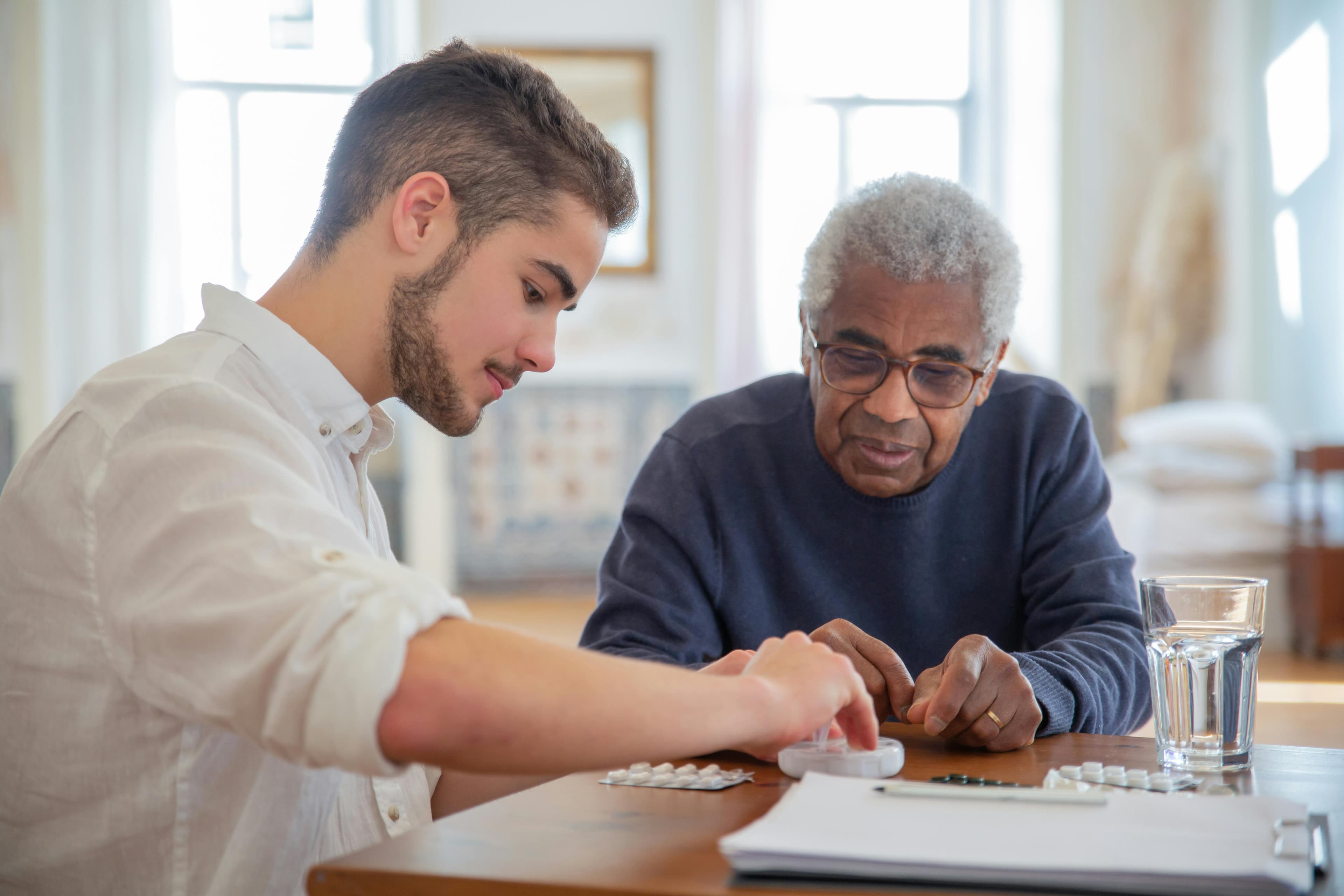 An elderly patient discussing medication side effects with a healthcare provider