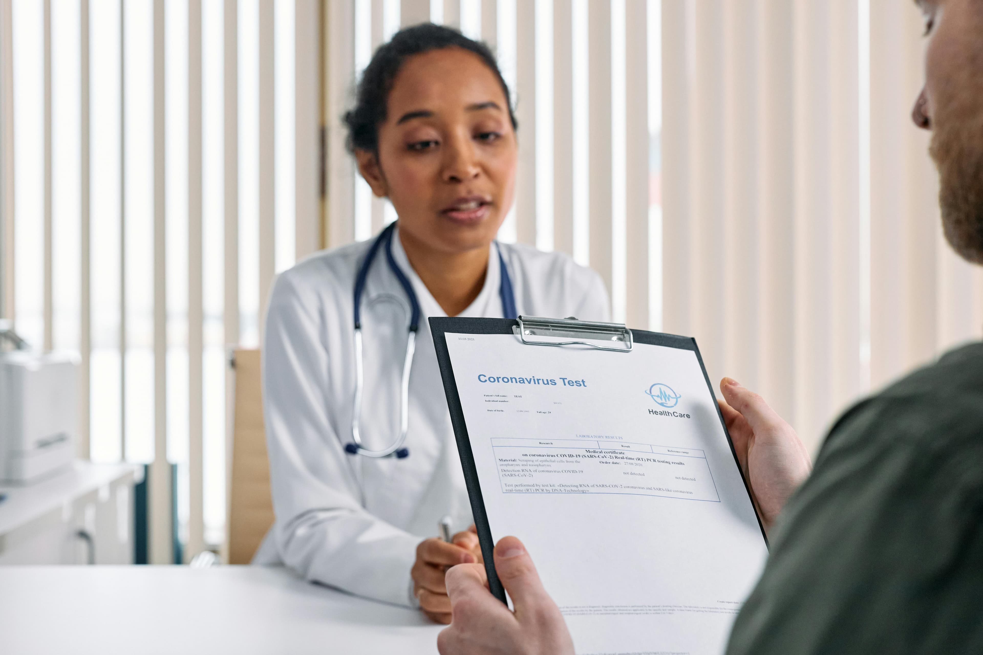 A doctor discussing test results with a patient in a clinical setting