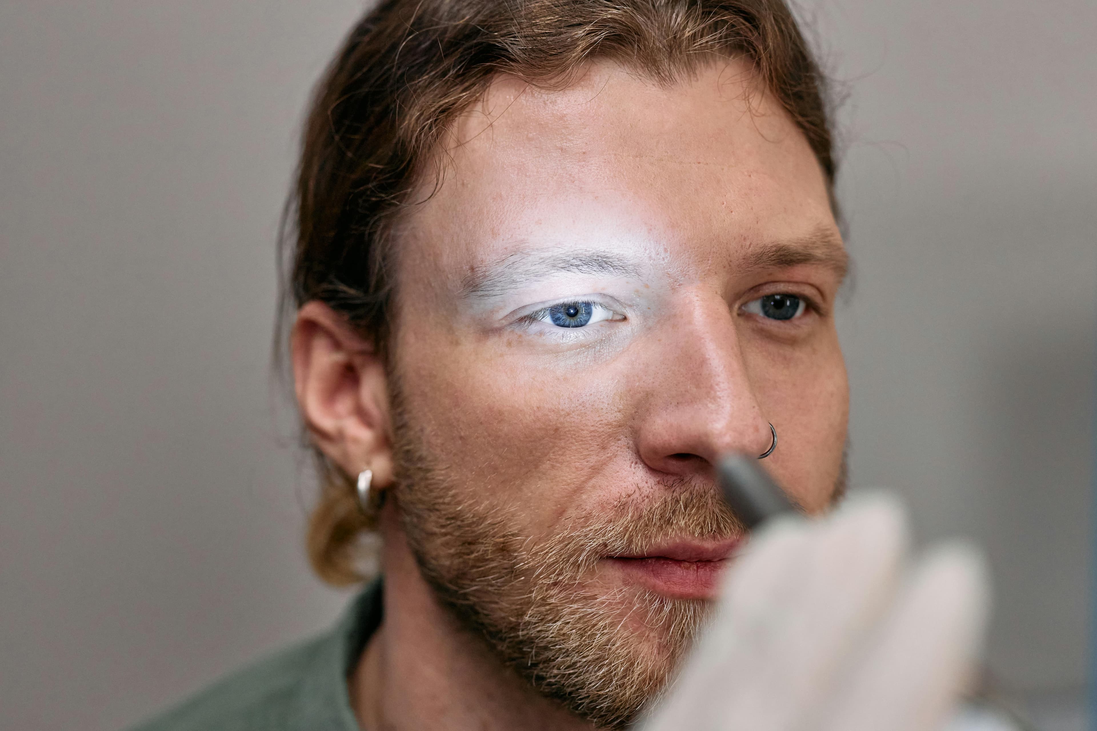 An optometrist performing an eye exam on a patient