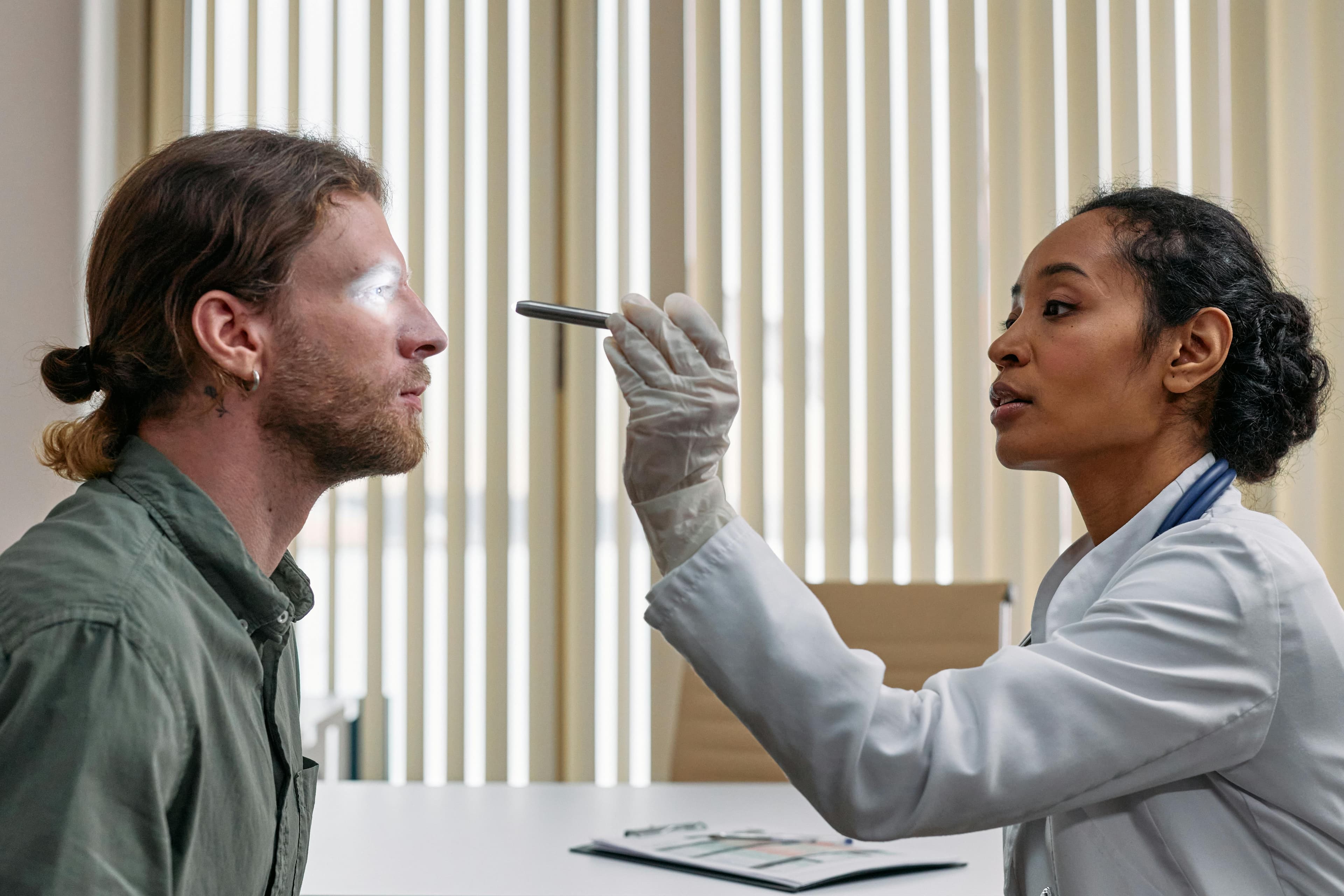 An ophthalmologist performing a comprehensive eye examination on a patient