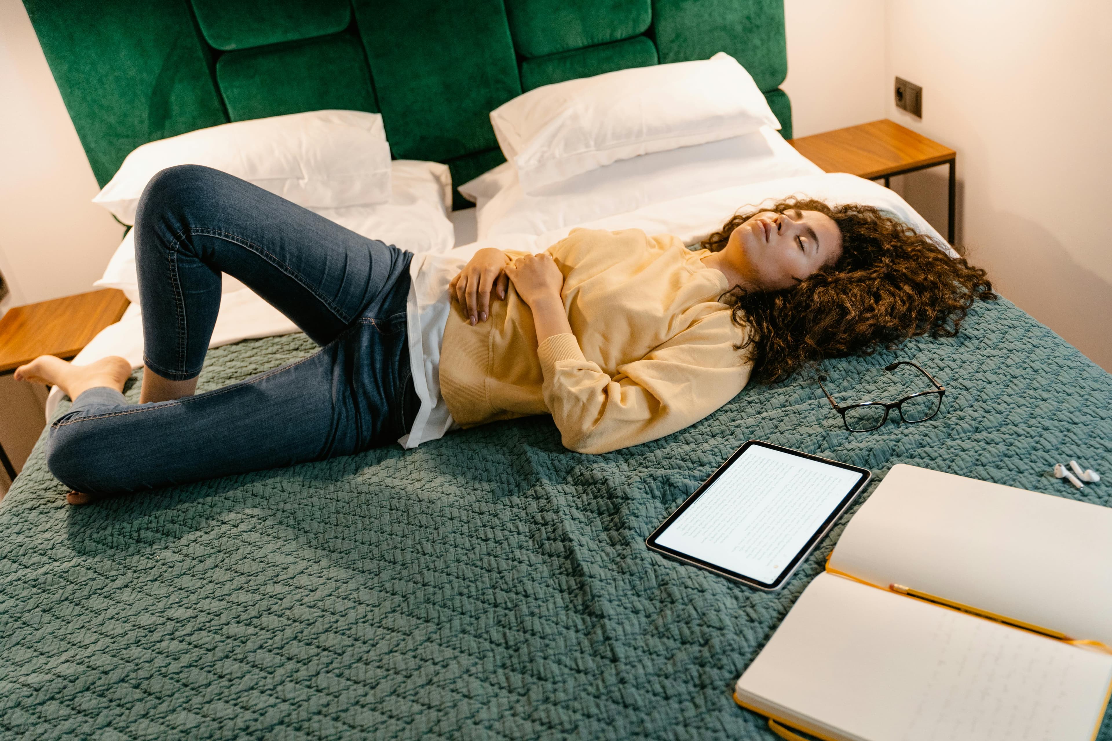 Person sleeping on their left side with pillows for support