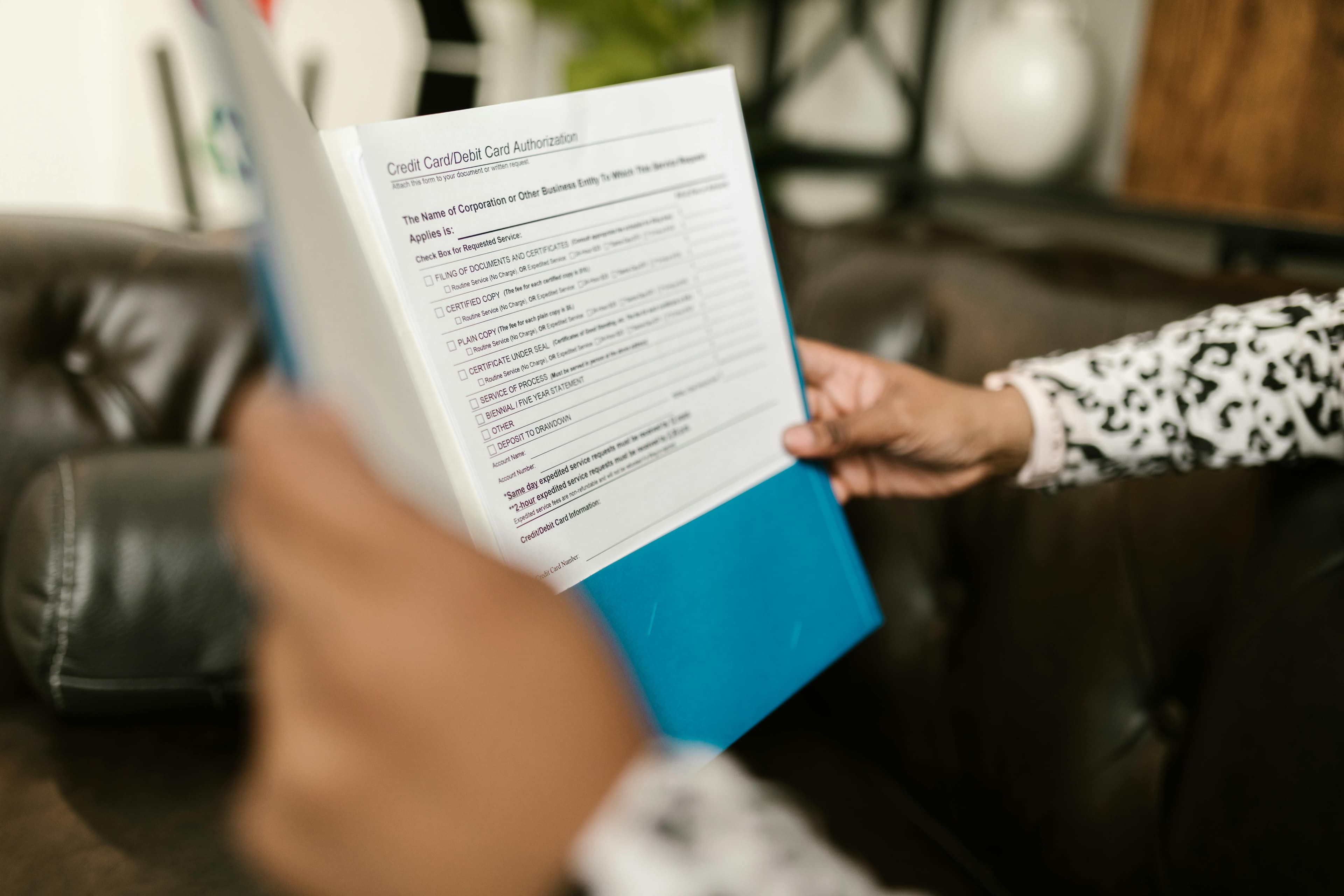 A person reviewing health insurance documents and bills related to acupuncture treatment
